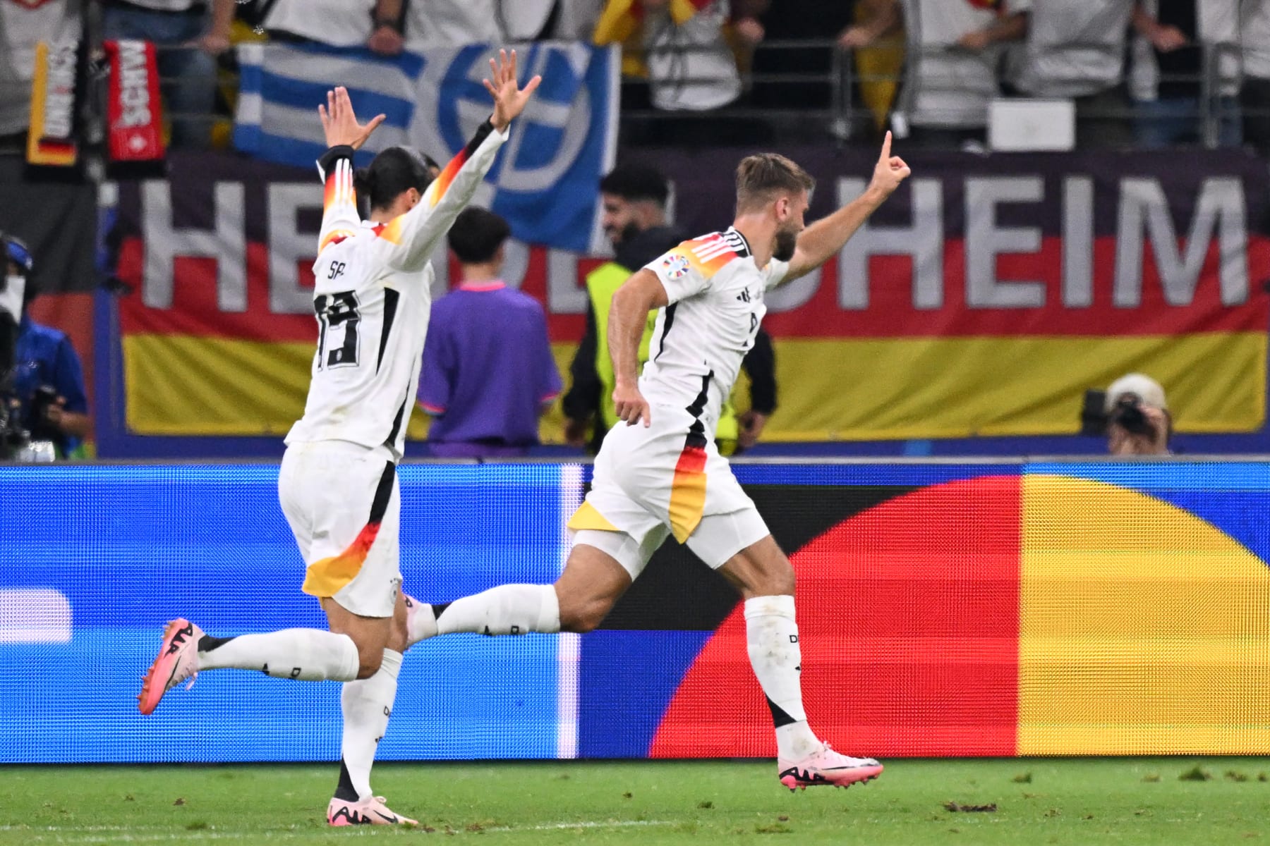 Germany's forward #09 Niclas Fuellkrug (R) celebrates scoring his team's first goal with his teammate Germany's midfielder #19 Leroy Sane during the UEFA Euro 2024 Group A football match between Switzerland and Germany at the Frankfurt Arena in Frankfurt am Main on June 23, 2024. (Photo by Kirill KUDRYAVTSEV / AFP) (Photo by KIRILL KUDRYAVTSEV/AFP via Getty Images)