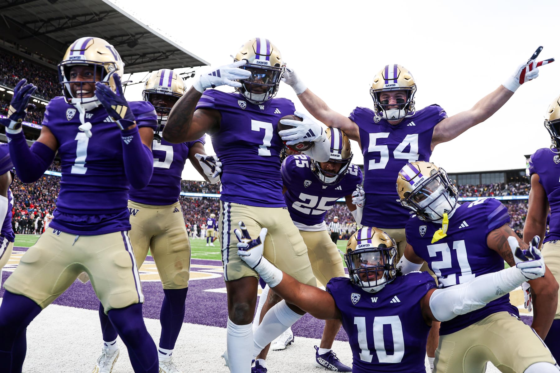 SEATTLE, WASHINGTON - NOVEMBER 11: Dominique Hampton #7 of the Washington Huskies celebrates with teammates after his interception against the Utah Utes during the fourth quarter at Husky Stadium on November 11, 2023 in Seattle, Washington. (Photo by Steph Chambers/Getty Images)