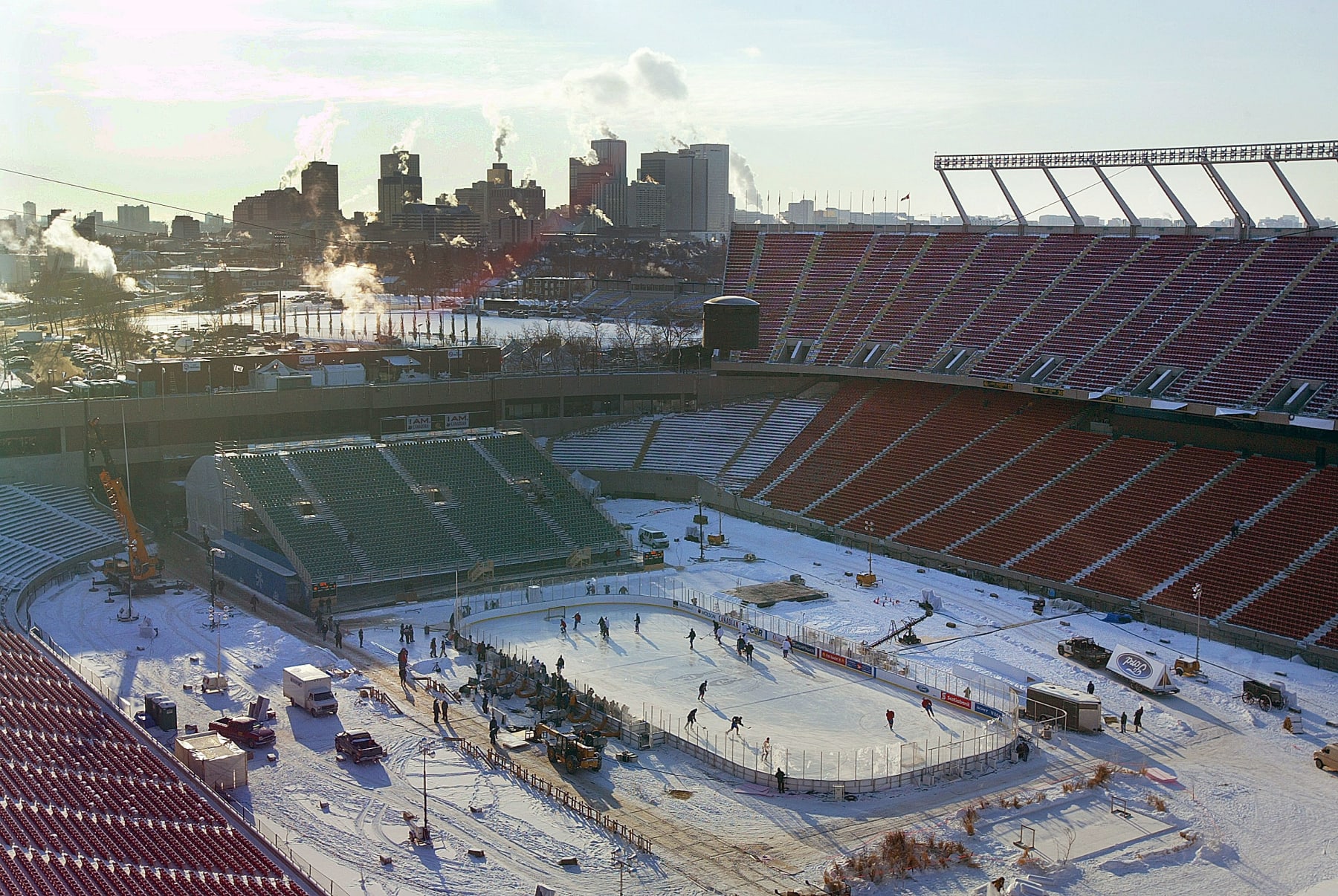 EDMONTON, ALBERTA - NOVEMBER 21:  Below zero temperatures cause steam to billow up from buildings in downtown Edmonton off in the distance as the Montreal Canadiens practice on an outdoor rink on November 21, 2003 at Commonwealth Stadium in Edmonton, Alberta. The Edmonton Oilers and the Montreal Canadiens will play in the Heritage Classic hockey game on November 22, the first time a regular season NHL game will be played outdoors.  (Photo by Jeff Vinnick/Getty Images)
