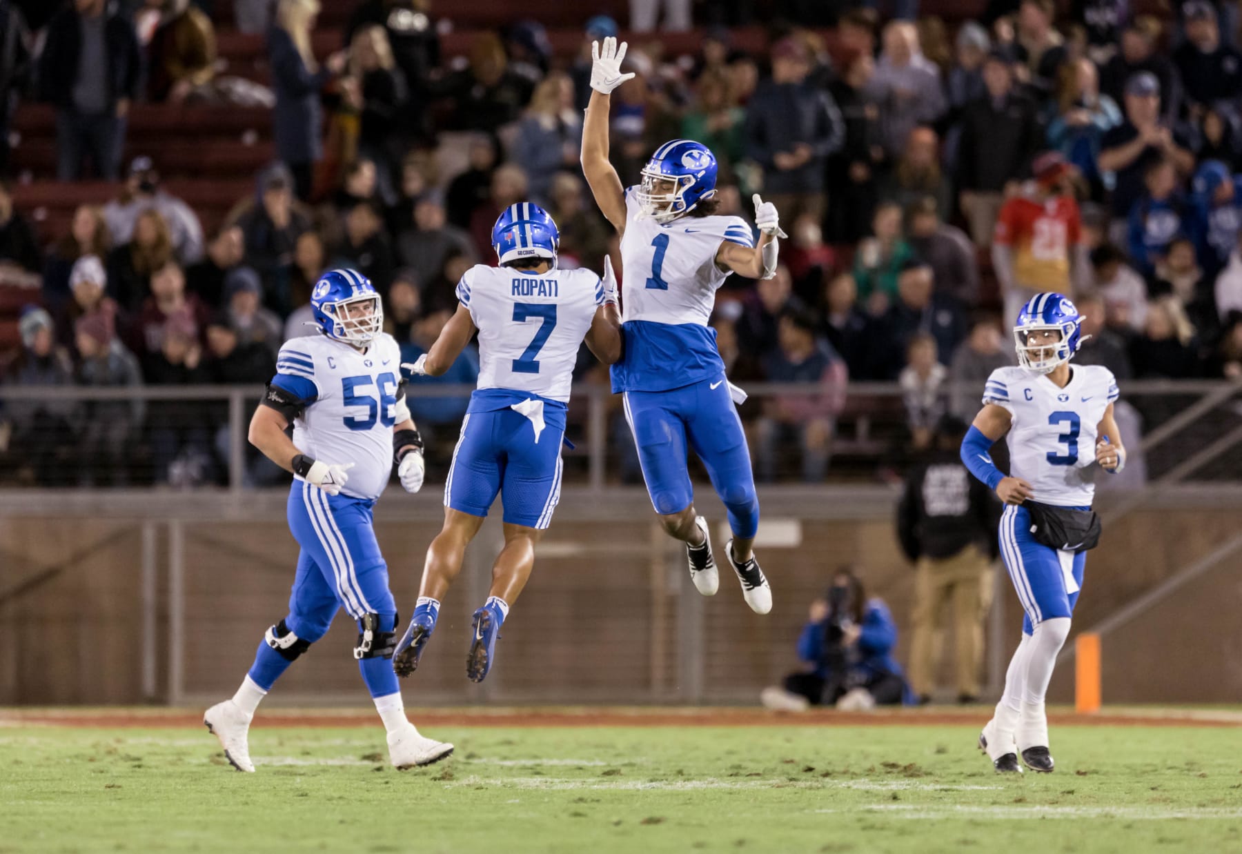 PALO ALTO, CA - NOVEMBER 26:  Keanu Hill #1, Hinckley Folau Ropati #7, Clark Barrington #56, and Jaren Hall #3 of the BYU Cougars celebrate during an NCAA college football game against the Stanford Cardinal on November 26, 2022 at Stanford Stadium in Palo Alto, California.  (Photo by David Madison/Getty Images)