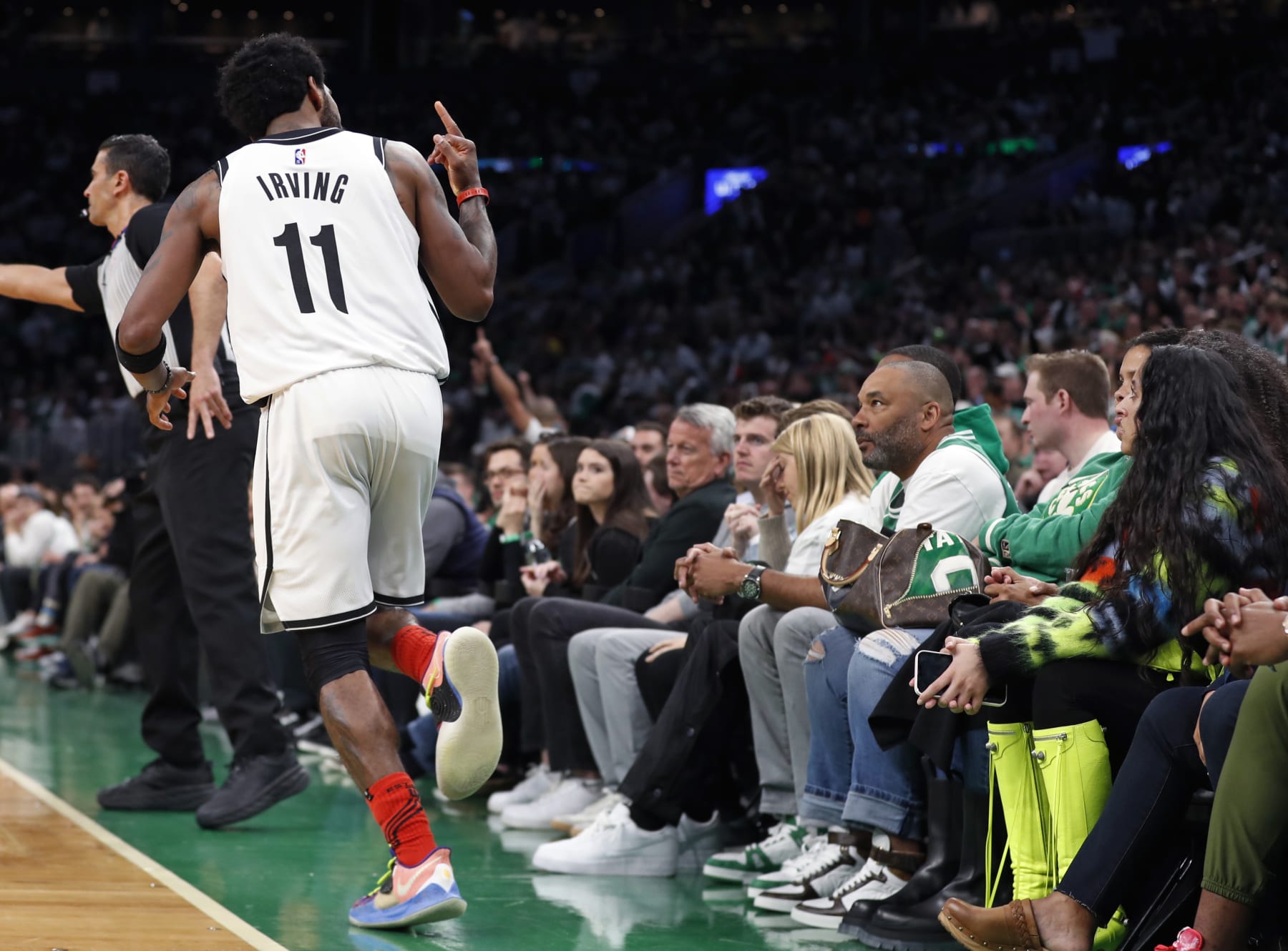 Boston - April 17: The Nets Kyrie Irving gestures with his middle finger at the fans after he made a third quarter shot. The Boston Celtics hosted the Brooklyn Nets in Game One of the NBA first round playoff series at the TD Garden in Boston on April 17, 2022. (Photo by Jim Davis/The Boston Globe via Getty Images)