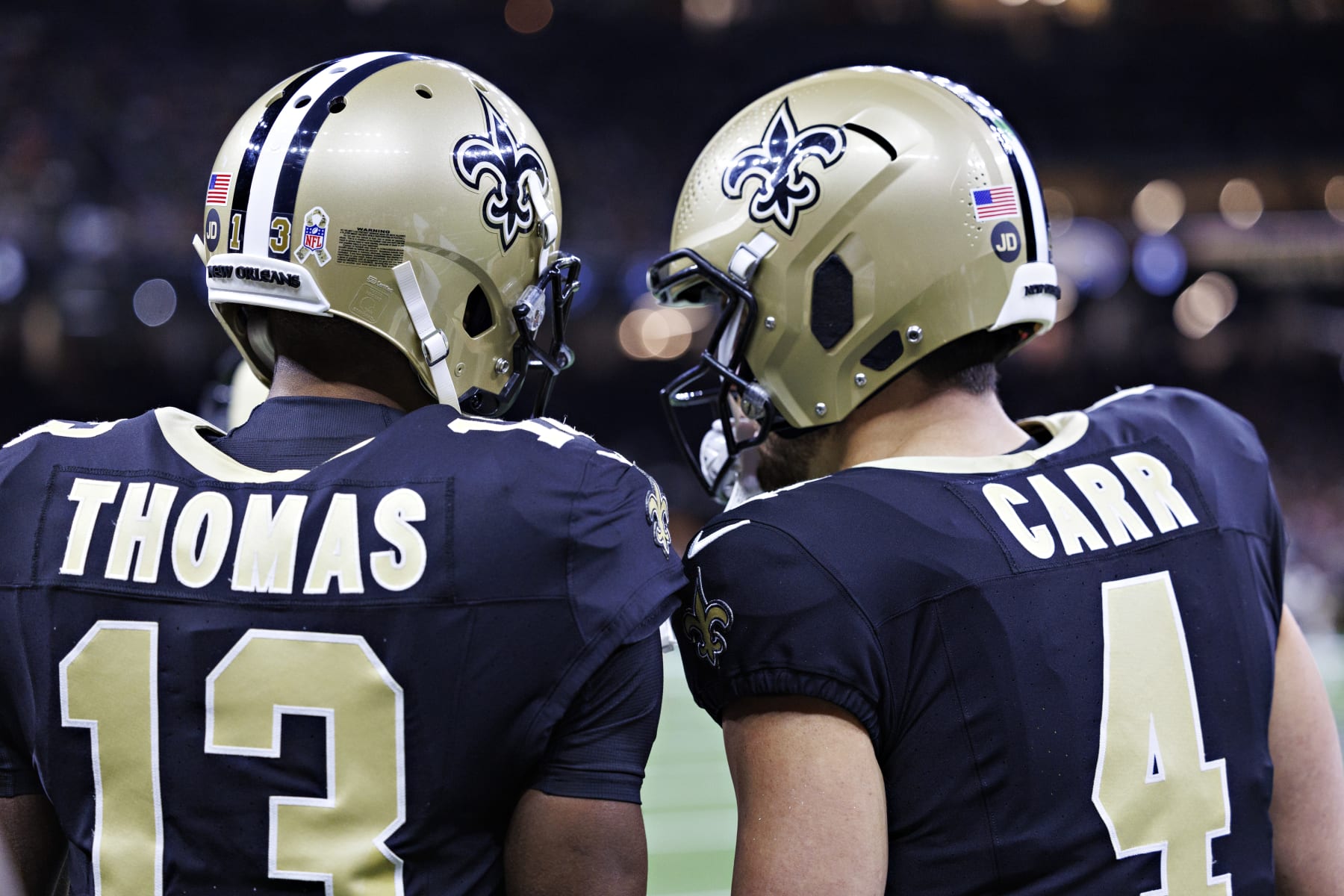 NEW ORLEANS, LOUISIANA - NOVEMBER 05:  Derek Carr #4 talks with Michael Thomas #13 of the New Orleans Saints on the sidelines during a game against the Chicago Bears at Caesars Superdome on November 5, 2023 in New Orleans, Louisiana. The Saints defeated the Bears 24-17. (Photo by Wesley Hitt/Getty Images)