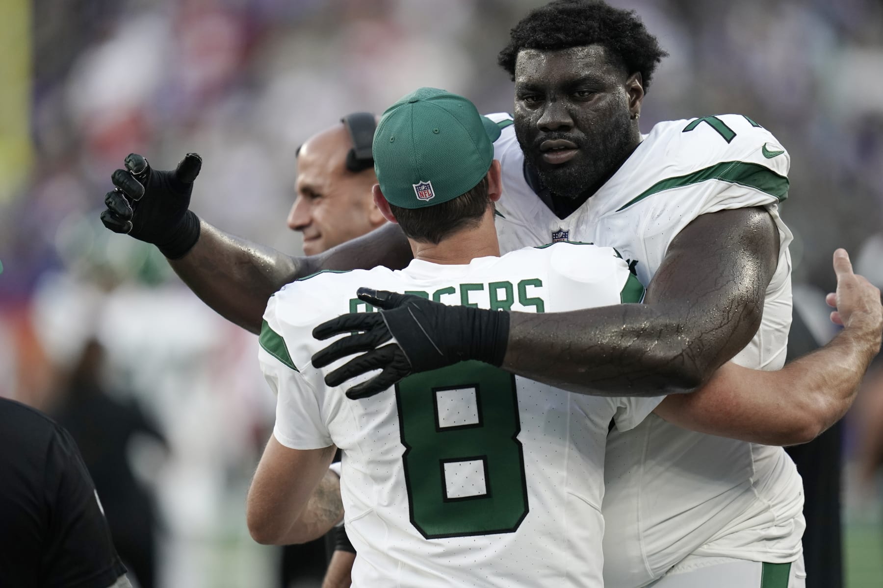 New York Jets offensive tackle Mekhi Becton (77) hugs quarterback Aaron Rodgers (8) during an NFL football game against the New York Giants, Saturday, Aug. 26, 2023 in East Rutherford, N.J. Jets won 32-24. (AP Photo/Vera Nieuwenhuis)