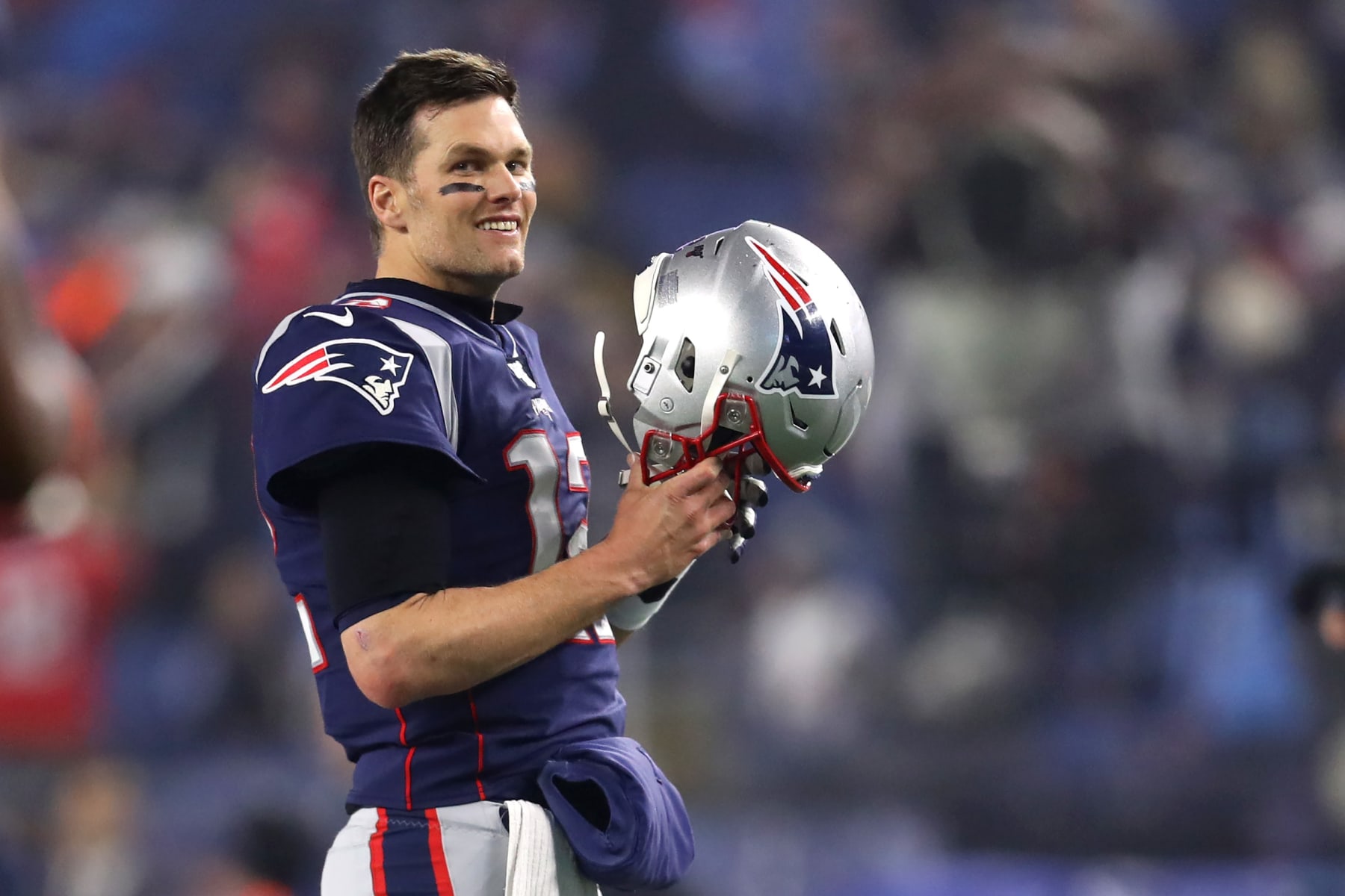 FOXBOROUGH, MASSACHUSETTS - JANUARY 04: Tom Brady #12 of the New England Patriots looks on holding his helmet before the AFC Wild Card Playoff game against the Tennessee Titans at Gillette Stadium on January 04, 2020 in Foxborough, Massachusetts. (Photo by Maddie Meyer/Getty Images)