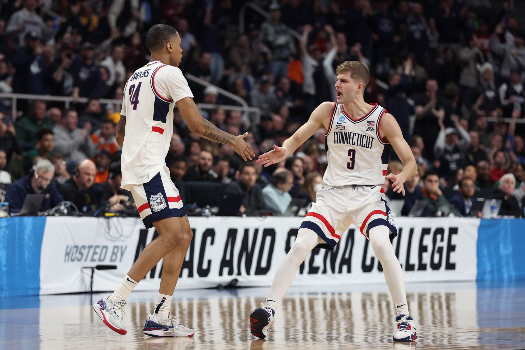ALBANY, NEW YORK - MARCH 19: Joey Calcaterra #3 and Jordan Hawkins #24 of the Connecticut Huskies celebrate in the second half against the St. Mary's Gaels during the second round of the NCAA Men's Basketball Tournament at MVP Arena on March 19, 2023 in Albany, New York. (Photo by Rob Carr/Getty Images)