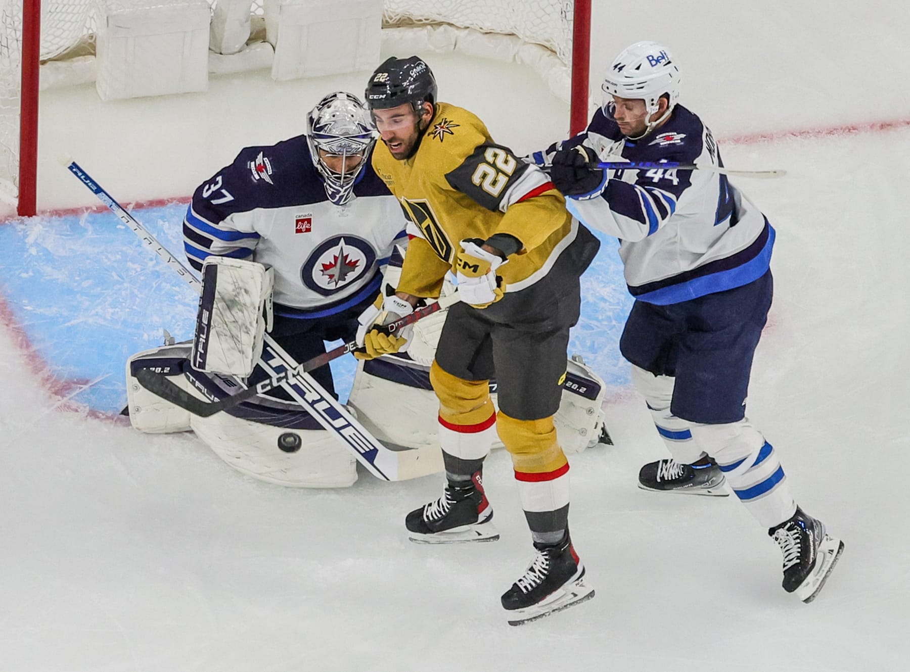 LAS VEGAS, NEVADA - APRIL 18: Michael Amadio #22 of the Vegas Golden Knights tries to redirect a shot past Connor Hellebuyck #37 of the Winnipeg Jets as Josh Morrissey #44 of the Jets defends in the first period of Game One of the First Round of the 2023 Stanley Cup Playoffs at T-Mobile Arena on April 18, 2023 in Las Vegas, Nevada. The Jets defeated the Golden Knights 5-1. (Photo by Ethan Miller/Getty Images)