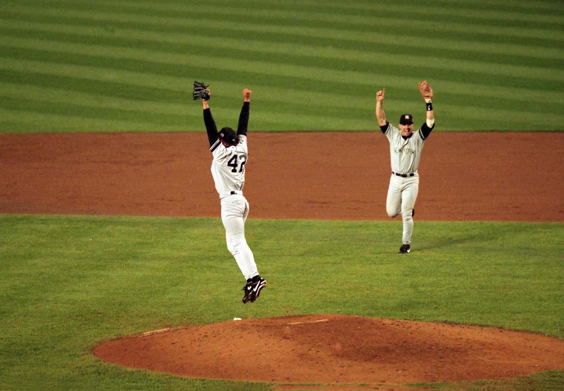 Baseball: World Series: New York Yankees Mariano Rivera (42) and Tino Martinez (24) in action, celebrate the final out vs New York Mets at Shea Stadium. Game 5. 
Flushing, NY 10/26/2000 
CREDIT: Chuck Solomon (Photo by Chuck Solomon/Sports Illustrated via Getty Images) 
(Set Number: X61703 TK5)