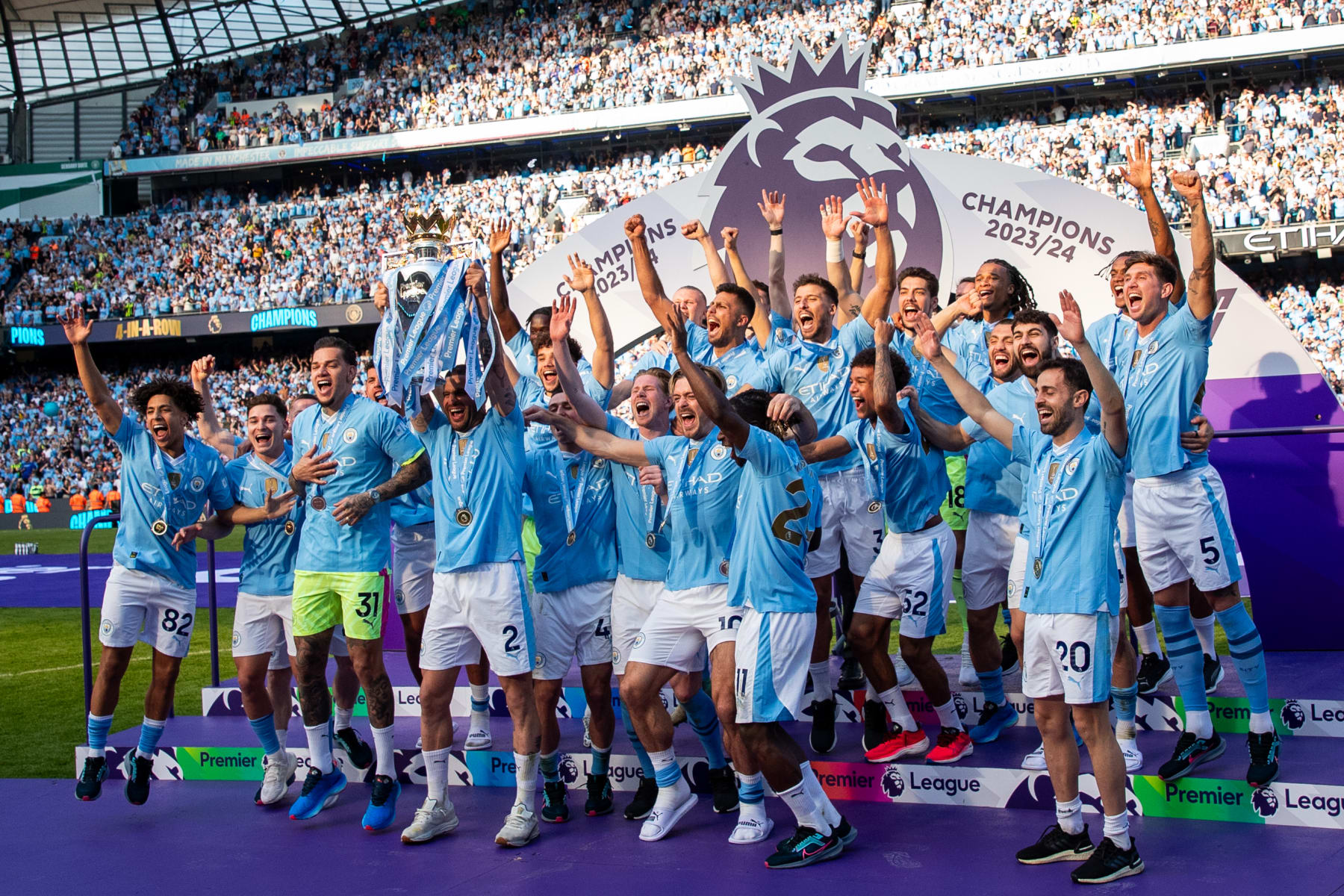 MANCHESTER, ENGLAND - MAY 19: Kyle Walker of Manchester City lifts the Premier League trophy with team mates for a record fourth consecutive time during the Premier League match between Manchester City and West Ham United at Etihad Stadium on May 19, 2024 in Manchester, England.(Photo by Robbie Jay Barratt - AMA/Getty Images)
