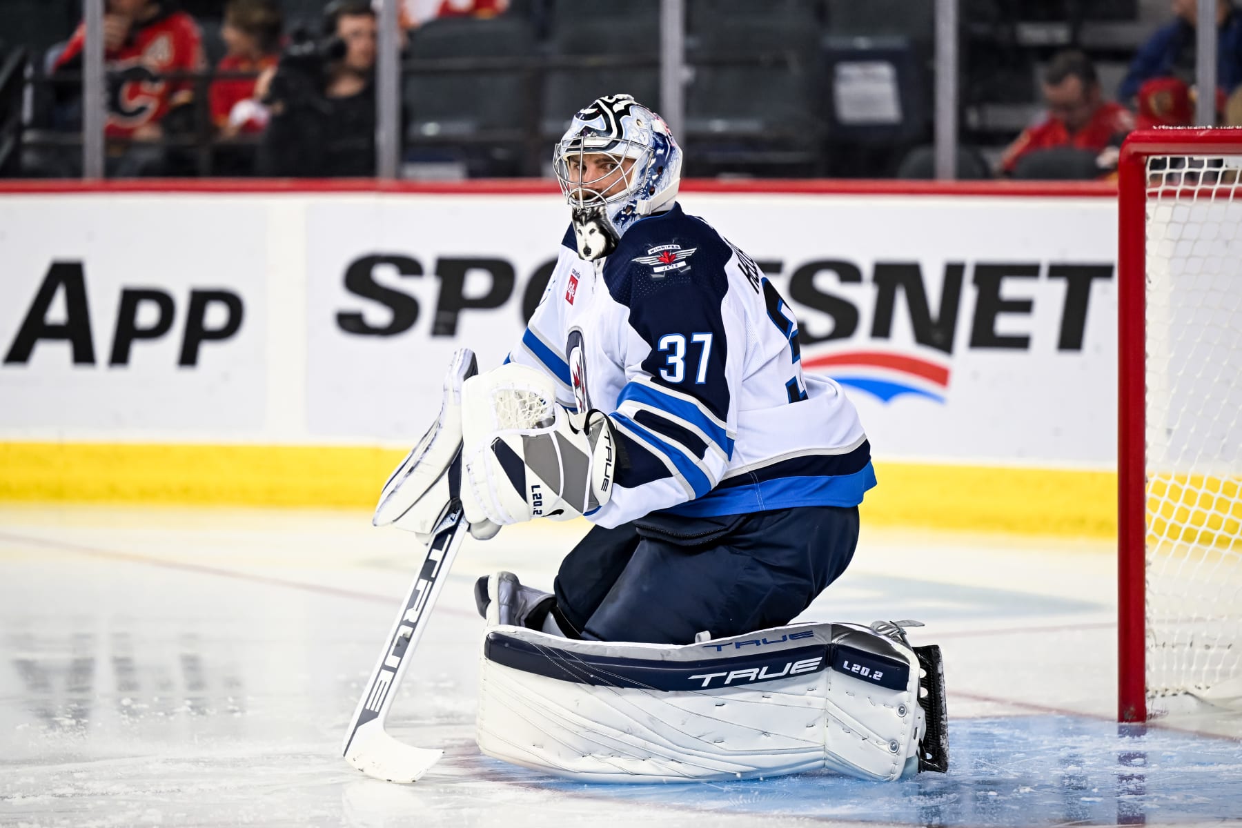 CALGARY, AB - OCTOBER 02: Winnipeg Jets Goalie Connor Hellebuyck (37) stretches during the first period of an NHL preseason game between the Calgary Flames and the Winnipeg Jets on October 2, 2023, at the Scotiabank Saddledome in Calgary, AB. (Photo by Brett Holmes/Icon Sportswire via Getty Images)