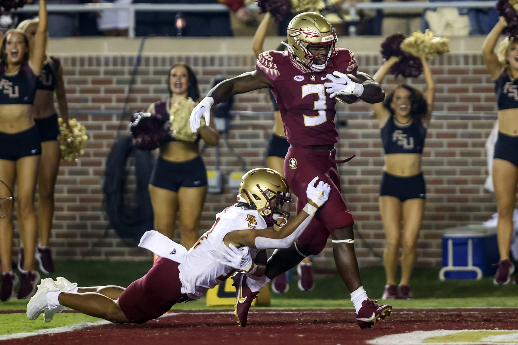 Florida State running back Trey Benson (3) returns the opening kickoff 93 yards for a touchdown, escaping Boston College's Lewis Bond (11) during an NCAA college football game on Saturday, Sept. 24, 2022, in Tallahassee, Fla. (AP Photo/Gary McCullough)