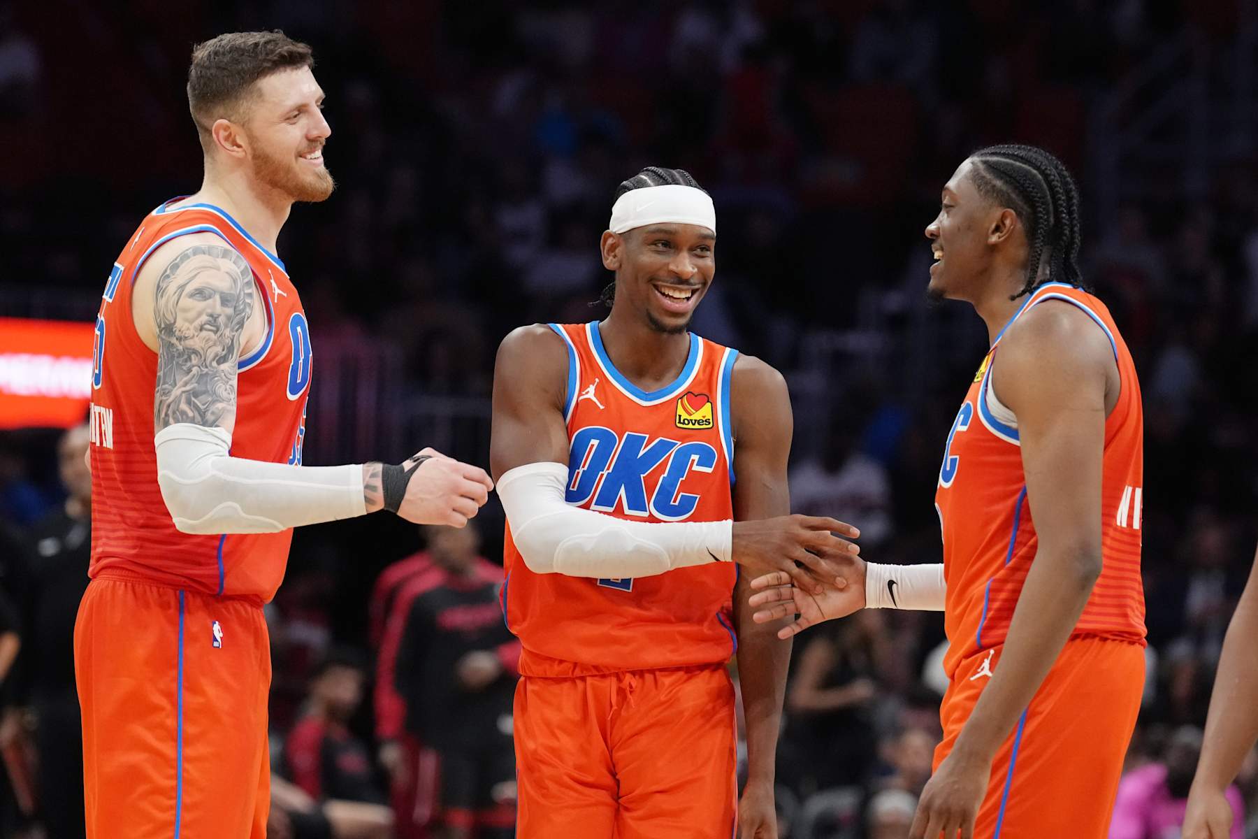 MIAMI, FL - DECEMBER 20: Shai Gilgeous-Alexander #2 and Duncan Robinson #55 and Jalen Williams #8 of the Oklahoma City Thunder smile during the game against the Miami Heat on December 20, 2024 at Kaseya Center in Miami, Florida. NOTE TO USER: User expressly acknowledges and agrees that, by downloading and or using this Photograph, user is consenting to the terms and conditions of the Getty Images License Agreement. Mandatory Copyright Notice: Copyright 2024 NBAE (Photo by Eric Espada/NBAE via Getty Images)