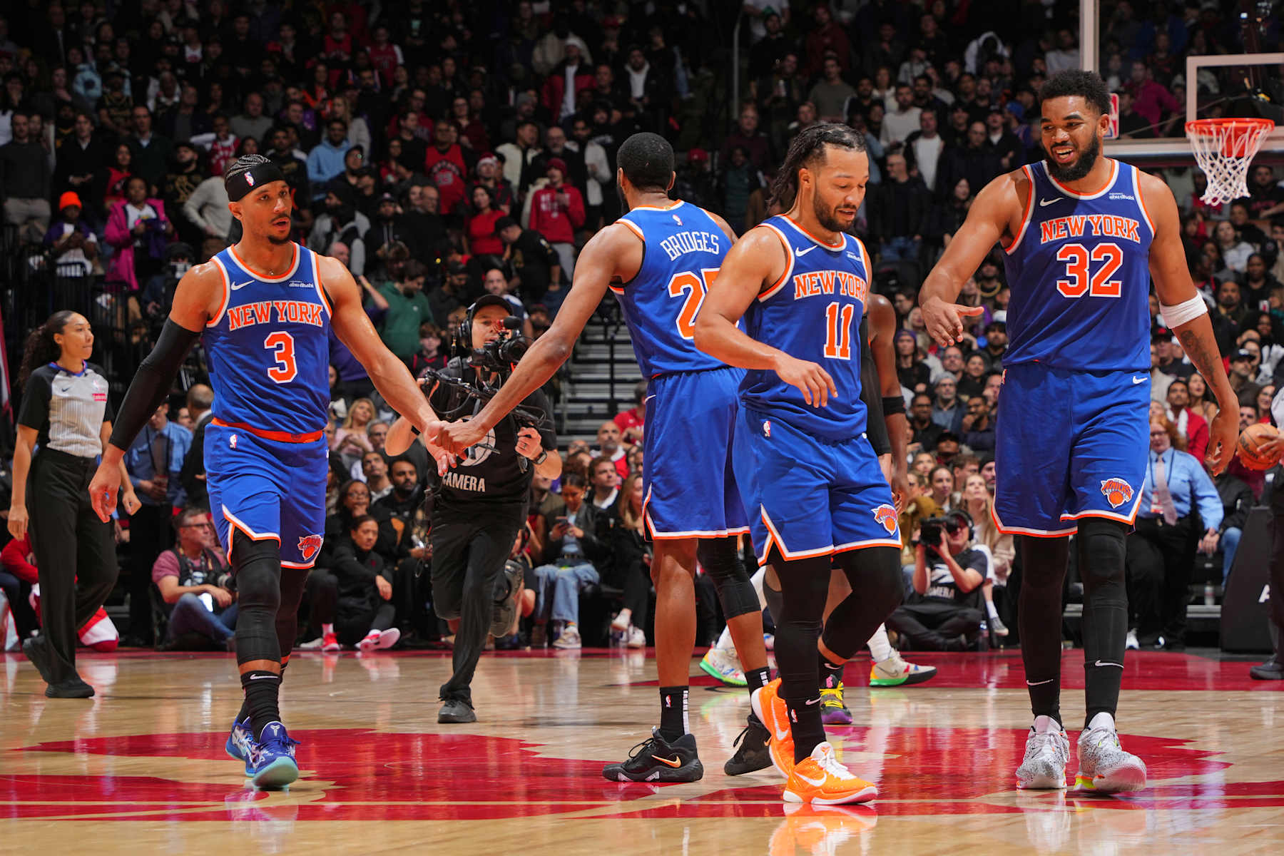 TORONTO, CANADA - DECEMBER 9: The New York Knicks celebrate during the game against the Toronto Raptors on December 9, 2024 at the Scotiabank Arena in Toronto, Ontario, Canada.  NOTE TO USER: User expressly acknowledges and agrees that, by downloading and or using this Photograph, user is consenting to the terms and conditions of the Getty Images License Agreement.  Mandatory Copyright Notice: Copyright 2024 NBAE (Photo by Mark Blinch/NBAE via Getty Images)