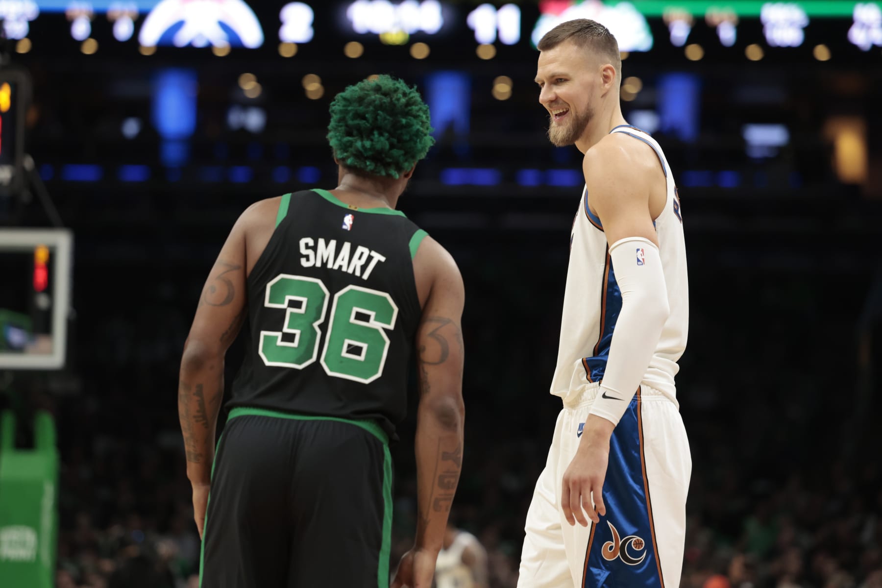 BOSTON, MASSACHUSETTS - OCTOBER 30: Kristaps Porzingis #6 of the Washington Wizards reacts with Marcus Smart #36 of the Boston Celtics during the first quarter of the game at TD Garden on October 30, 2022 in Boston, Massachusetts. NOTE TO USER: User expressly acknowledges and agrees that, by downloading and or using this photograph, User is consenting to the terms and conditions of the Getty Images License Agreement. (Photo by Nick Grace/Getty Images)