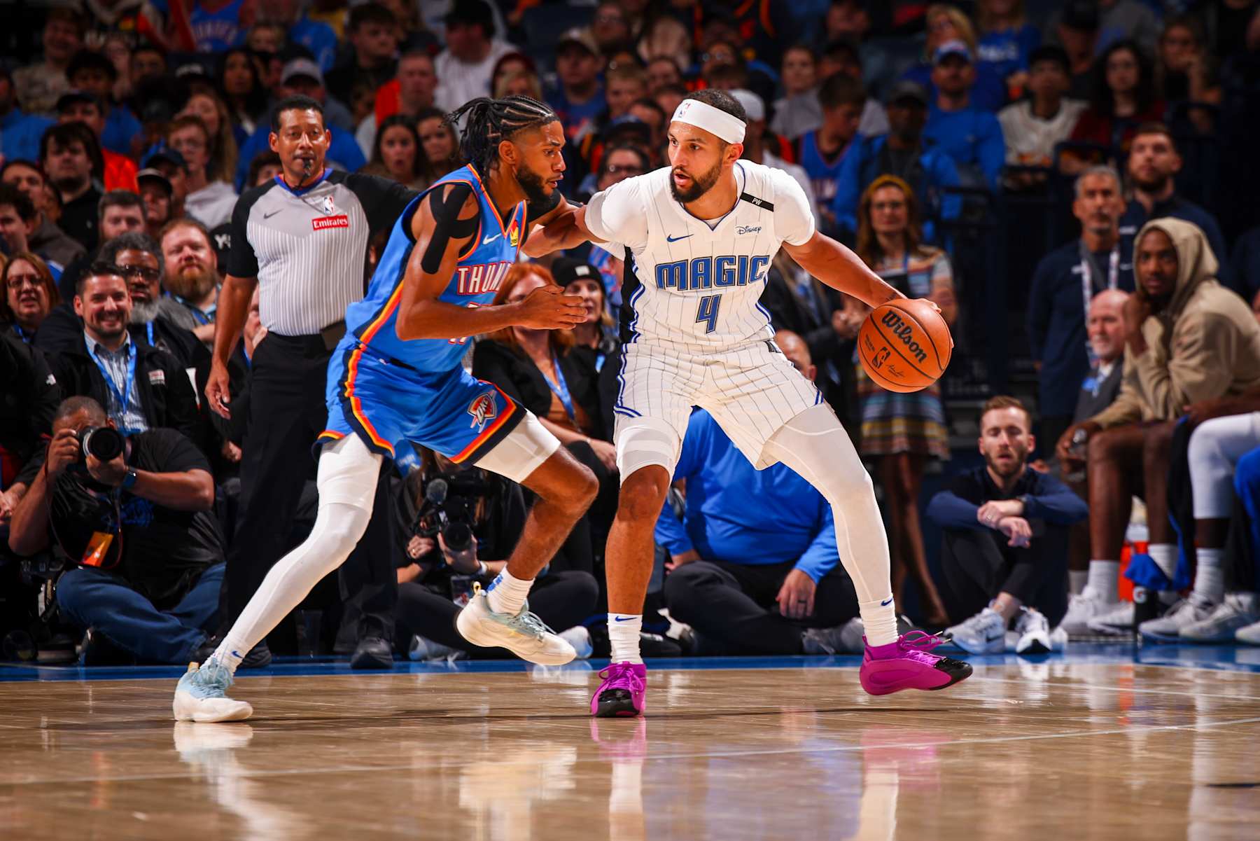 OKLAHOMA CITY, OK - NOVEMBER 4:  Jalen Suggs #4 of the Orlando Magic dribbles the ball during the game against the Oklahoma City Thunder on November 4, 2024 at Paycom Center in Oklahoma City, Oklahoma. NOTE TO USER: User expressly acknowledges and agrees that, by downloading and or using this photograph, User is consenting to the terms and conditions of the Getty Images License Agreement. Mandatory Copyright Notice: Copyright 2024 NBAE (Photo by Zach Beeker/NBAE via Getty Images)