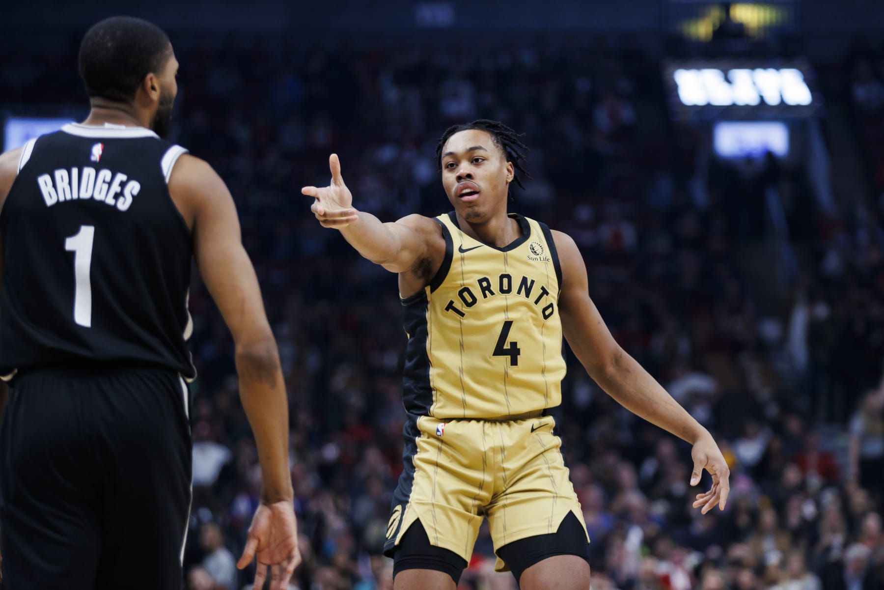 TORONTO, CANADA - FEBRUARY 22: Scottie Barnes #4 of the Toronto Raptors celebrates in front of Mikal Bridges #1 of the Brooklyn Nets after scoring in the first half of their NBA game at Scotiabank Arena on February 22, 2024 in Toronto, Canada. NOTE TO USER: User expressly acknowledges and agrees that, by downloading and or using this photograph, User is consenting to the terms and conditions of the Getty Images License Agreement. (Photo by Cole Burston/Getty Images)