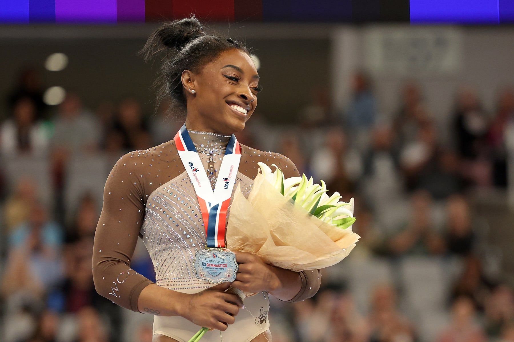 FORT WORTH, TEXAS - JUNE 02: First place all around winner Simone Biles celebrates after the 2024 Xfinity U.S. Gymnastics Championships at Dickies Arena on June 02, 2024 in Fort Worth, Texas. (Photo by Elsa/Getty Images)