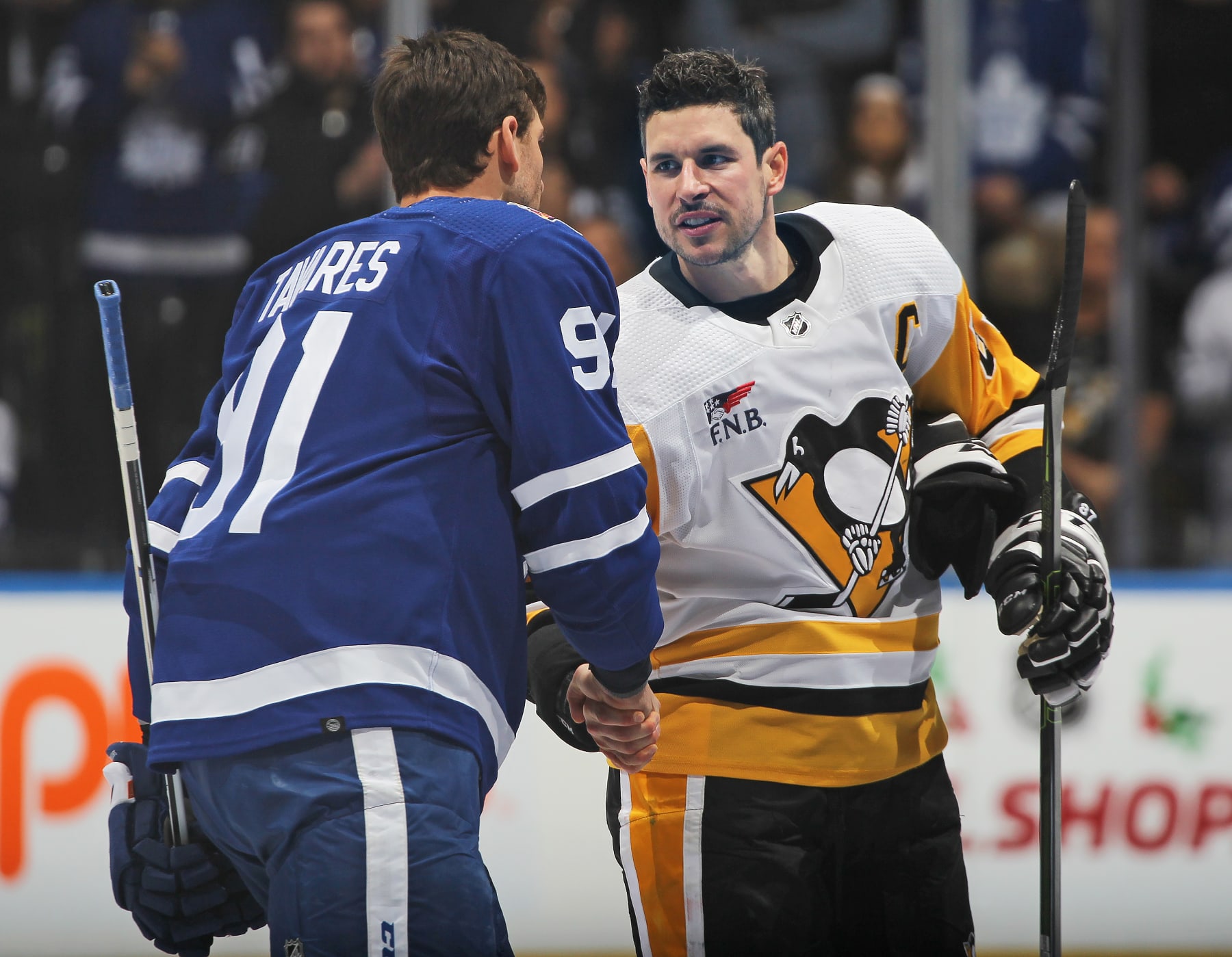 TORONTO, CANADA - DECEMBER 16:  Sidney Crosby #87 of the Pittsburgh Penguins shakes hands with John Tavares #91 of the Toronto Maple Leafs prior to action in the first period in an NHL game at Scotiabank Arena on December 16, 2023 in Toronto, Ontario, Canada. The Maple Leafs defeated the Penguins 7-0. (Photo by Claus Andersen/Getty Images)