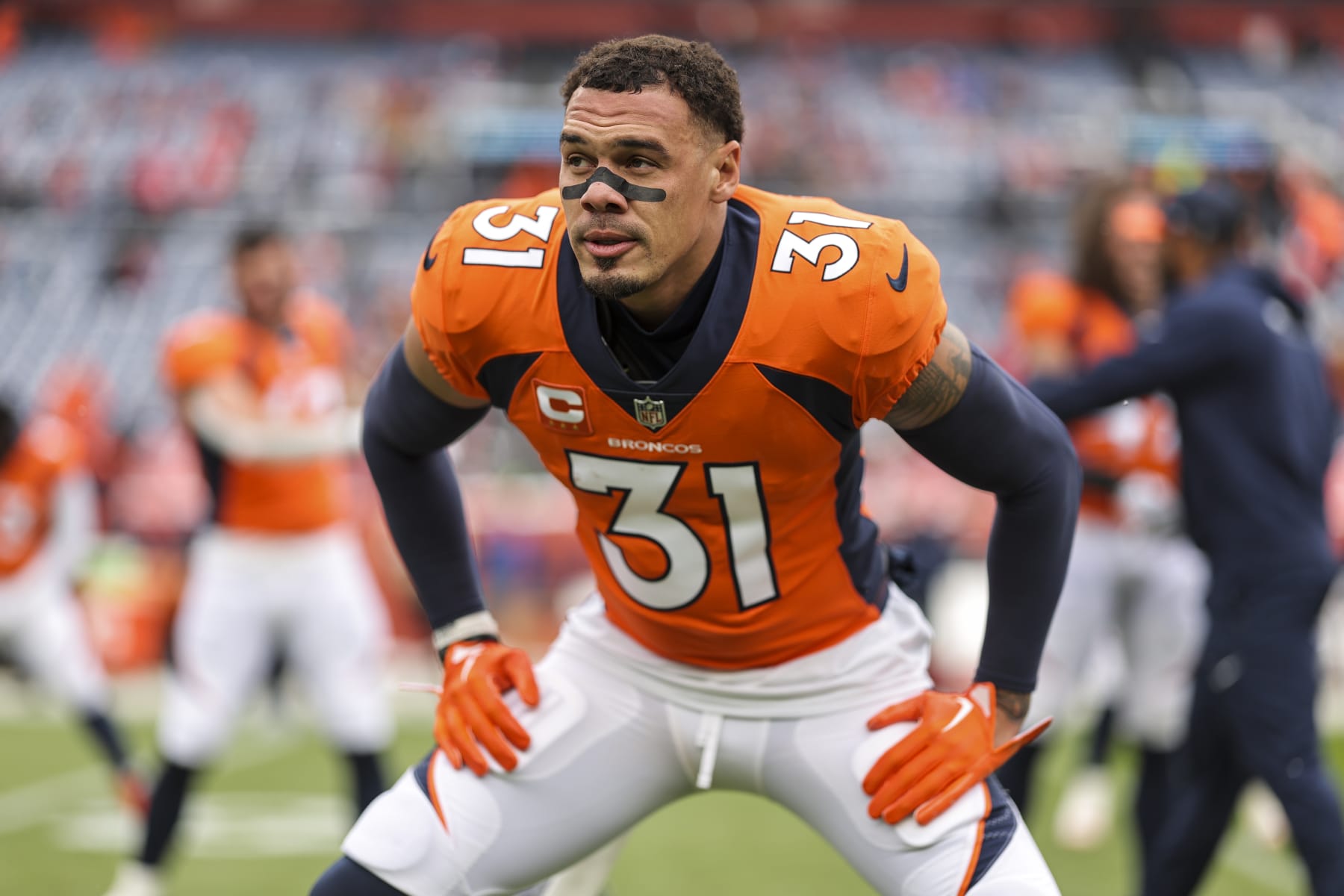 DENVER, COLORADO - OCTOBER 29: Justin Simmons #31 of the Denver Broncos stretches as he warms up prior to an NFL football game between the Denver Broncos and the Kansas City Chiefs at Empower Field At Mile High on October 29, 2023 in Denver, Colorado. (Photo by Michael Owens/Getty Images)
