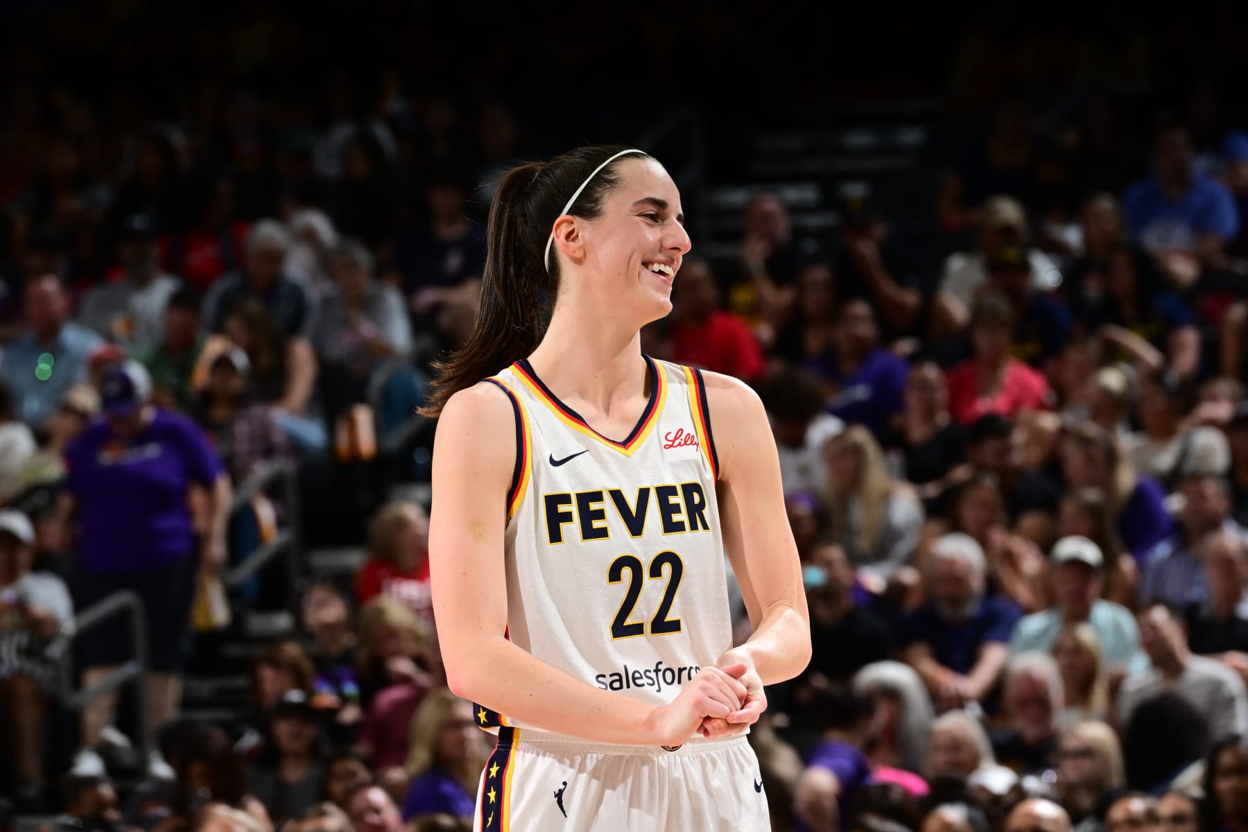 PHOENIX, AZ - JUNE 30: Caitlin Clark #22 of the Indiana Fever smiles during the game against the Phoenix Mercury on June 30, 2024 at Footprint Center in Phoenix, Arizona. NOTE TO USER: User expressly acknowledges and agrees that, by downloading and or using this photograph, user is consenting to the terms and conditions of the Getty Images License Agreement. Mandatory Copyright Notice: Copyright 2024 NBAE (Photo by Kate Frese/NBAE via Getty Images)