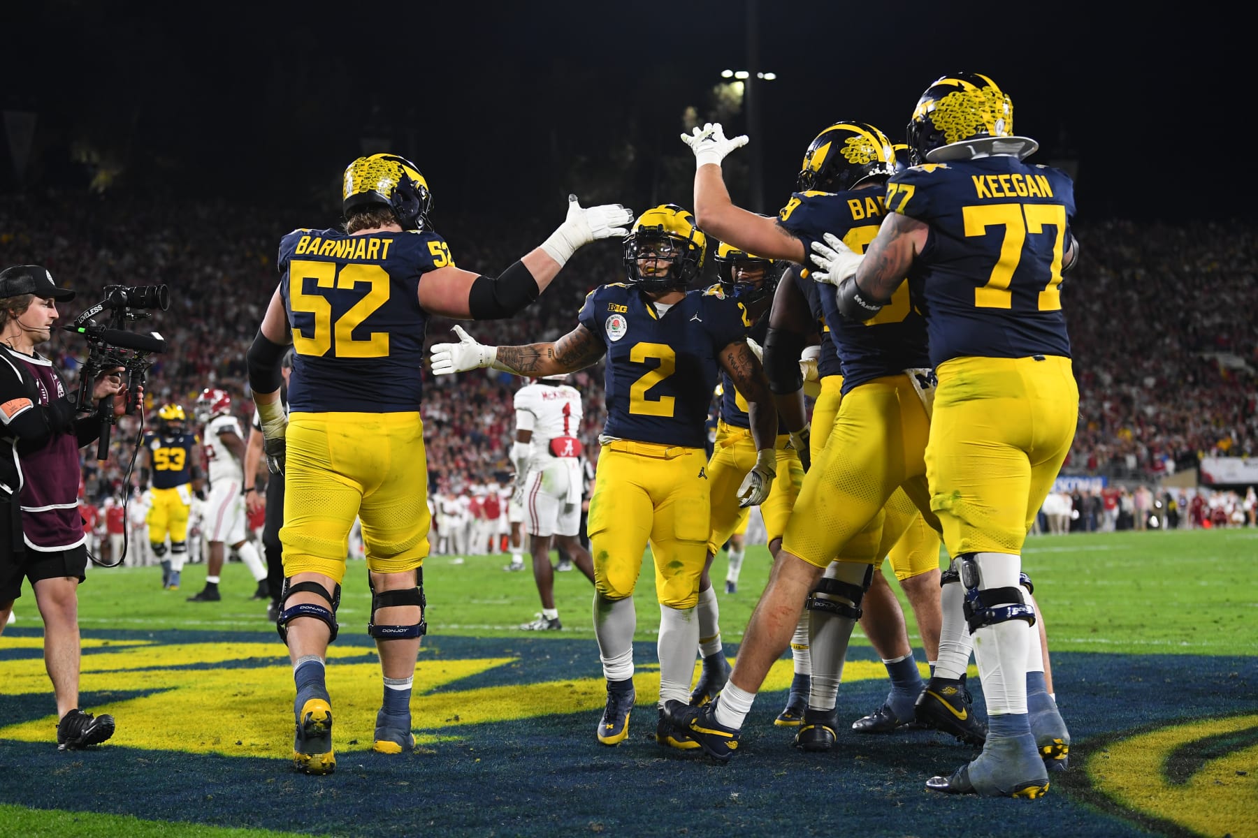 PASADENA, CA - JANUARY 01: RB Blake Corum (2) of the Michigan Wolverines celebrates with teammates after scoring a touchdown in overtime of the Alabama Crimson Tide game versus the Michigan Wolverines CFP Semifinal at the Rose Bowl Game on January, 1, 2024, at the Rose Bowl Stadium in Pasadena, CA. (Photo by Brian Rothmuller/Icon Sportswire via Getty Images)