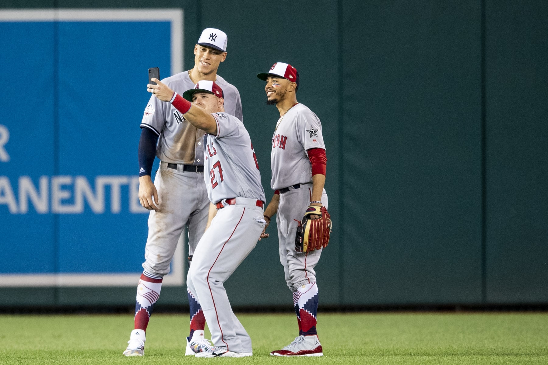 WASHINGTON, DC - JULY 17: Aaron Judge #99 of the New York Yankees, Mike Trout #27 of the Los Angeles Angels of Anaheim, and Mookie Betts #50 of the Boston Red Sox pose for a selfie photograph in the outfield during the fourth inning of the 89th MLB All-Star Game at Nationals Park Tuesday, July 17, 2018 in Washington, DC. (Photo by Billie Weiss/Boston Red Sox/Getty Images)