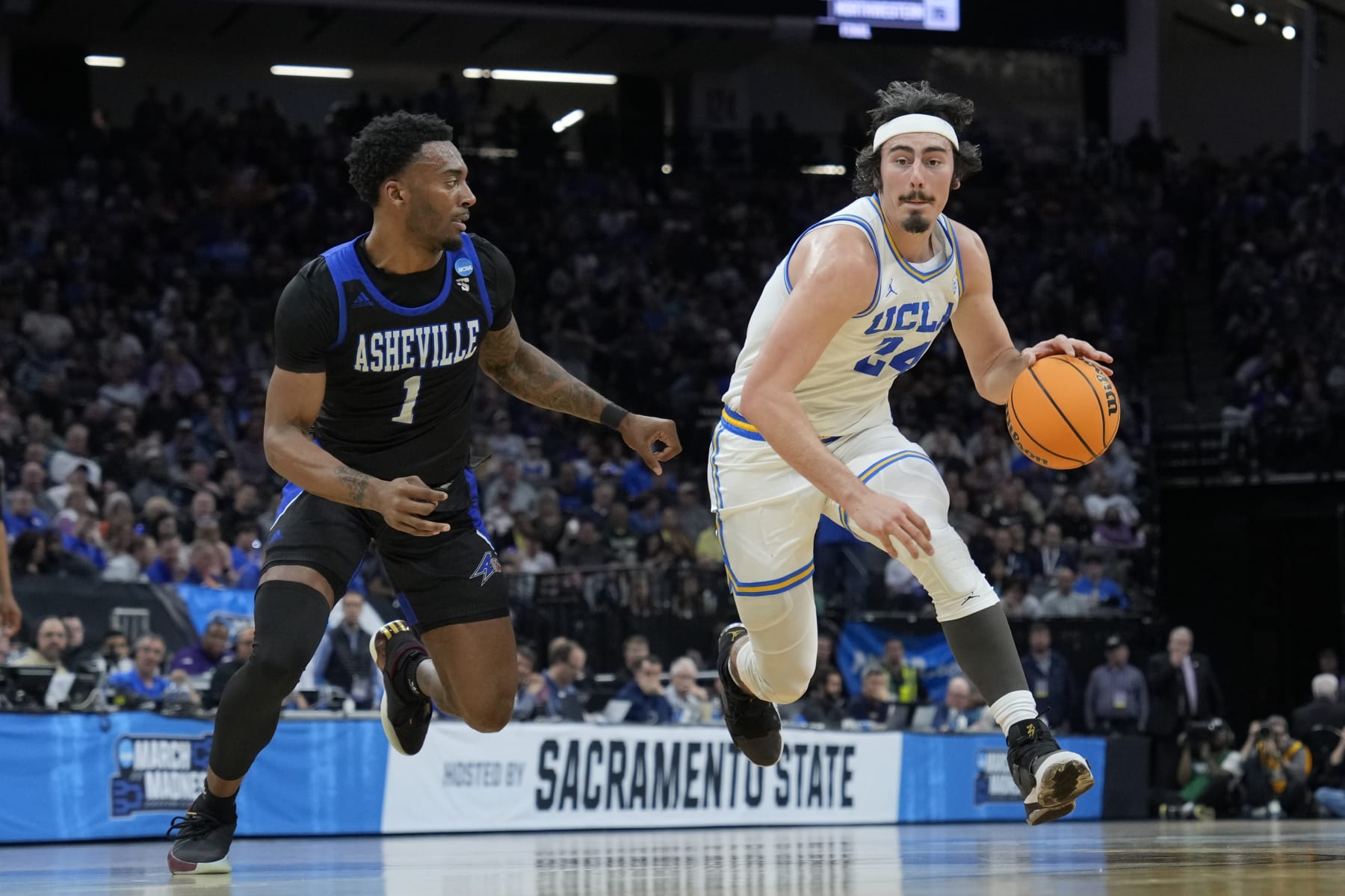 SACRAMENTO, CALIFORNIA - MARCH 16: Jaime Jaquez Jr. #24 of the UCLA Bruins works his way around Jamon Battle #1 of the North Carolina-Asheville Bulldogs during the first half in the first round of the NCAA Men's Basketball Tournament at Golden 1 Center on March 16, 2023 in Sacramento, California. (Photo by Thearon W. Henderson/Getty Images)
