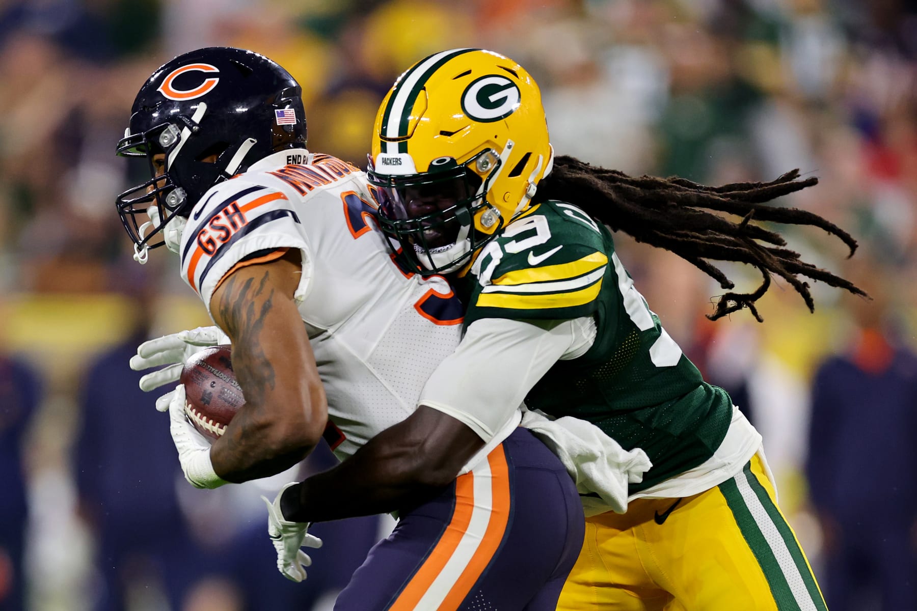 GREEN BAY, WISCONSIN - SEPTEMBER 18: David Montgomery #32 of the Chicago Bears is tackled by De'Vondre Campbell #59 of the Green Bay Packers during the second half at Lambeau Field on September 18, 2022 in Green Bay, Wisconsin. (Photo by Michael Reaves/Getty Images)