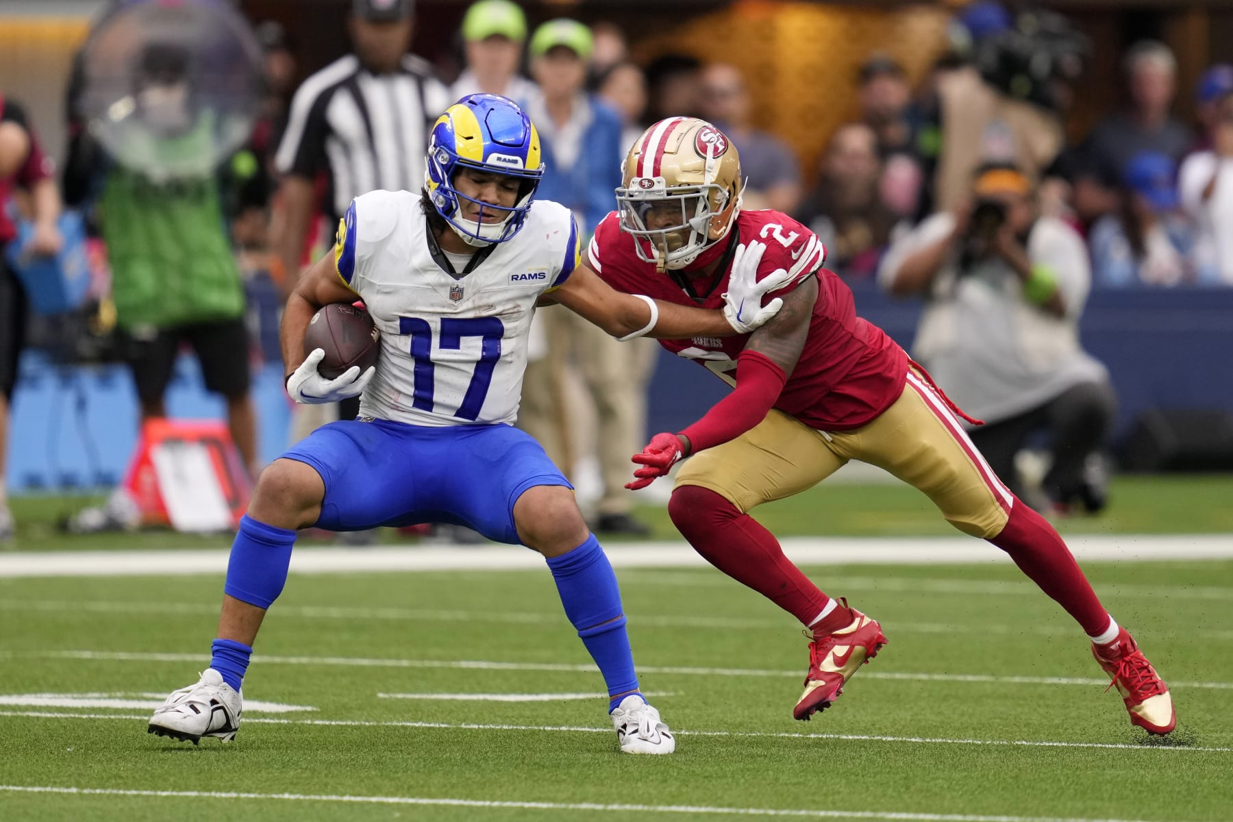 Los Angeles Rams wide receiver Puka Nacua, left, tries to fend off San Francisco 49ers cornerback Deommodore Lenoir during the second half of an NFL football game Sunday, Sept. 17, 2023, in Inglewood, Calif. (AP Photo/Ashley Landis) Los Angeles Rams wide receiver Puka Nacua, left, tries to fend off San Francisco 49ers cornerback Deommodore Lenoir during the second half of an NFL football game Sunday, Sept. 17, 2023, in Inglewood, Calif. (AP Photo/Ashley Landis)