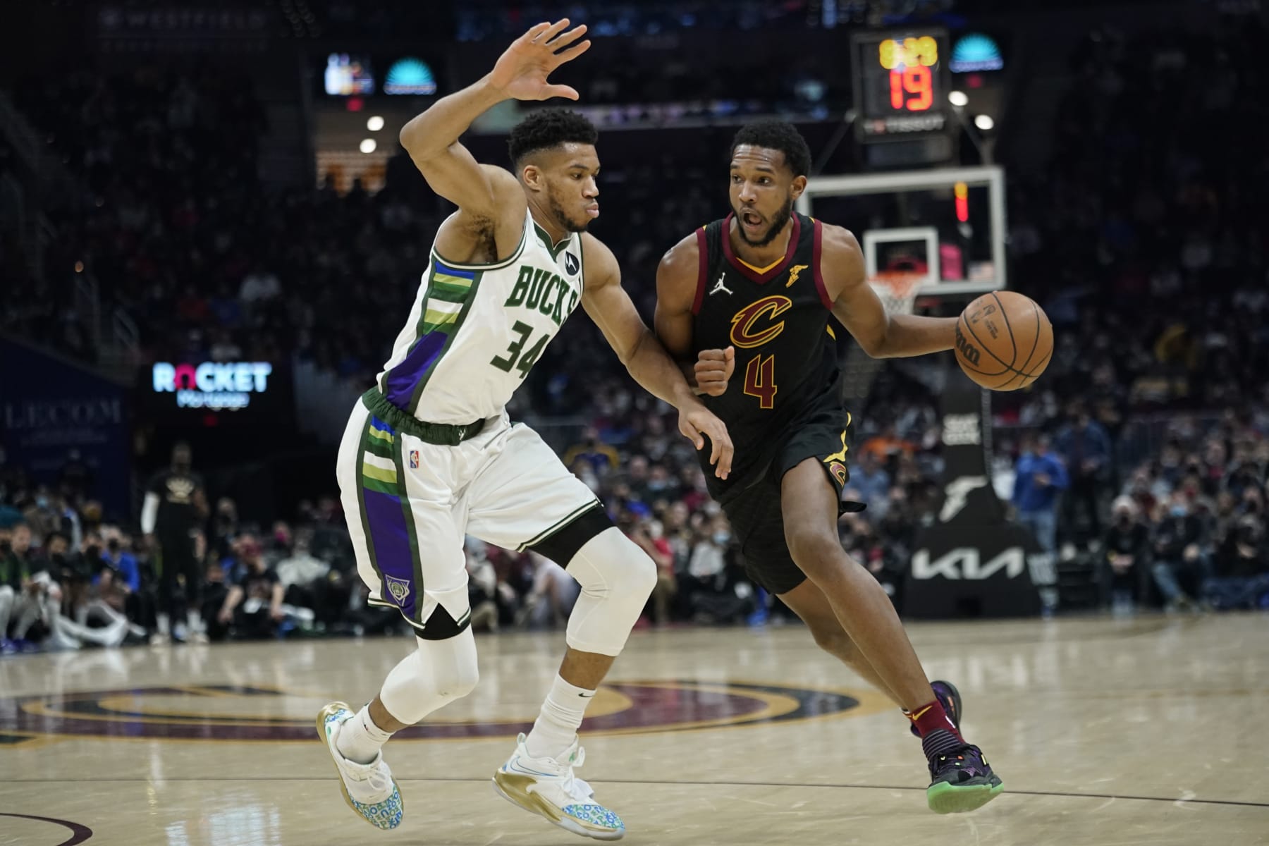 Cleveland Cavaliers' Evan Mobley (4) drives against Milwaukee Bucks' Giannis Antetokounmpo (34) in the second half of an NBA basketball game, Wednesday, Jan. 26, 2022, in Cleveland. (AP Photo/Tony Dejak)
