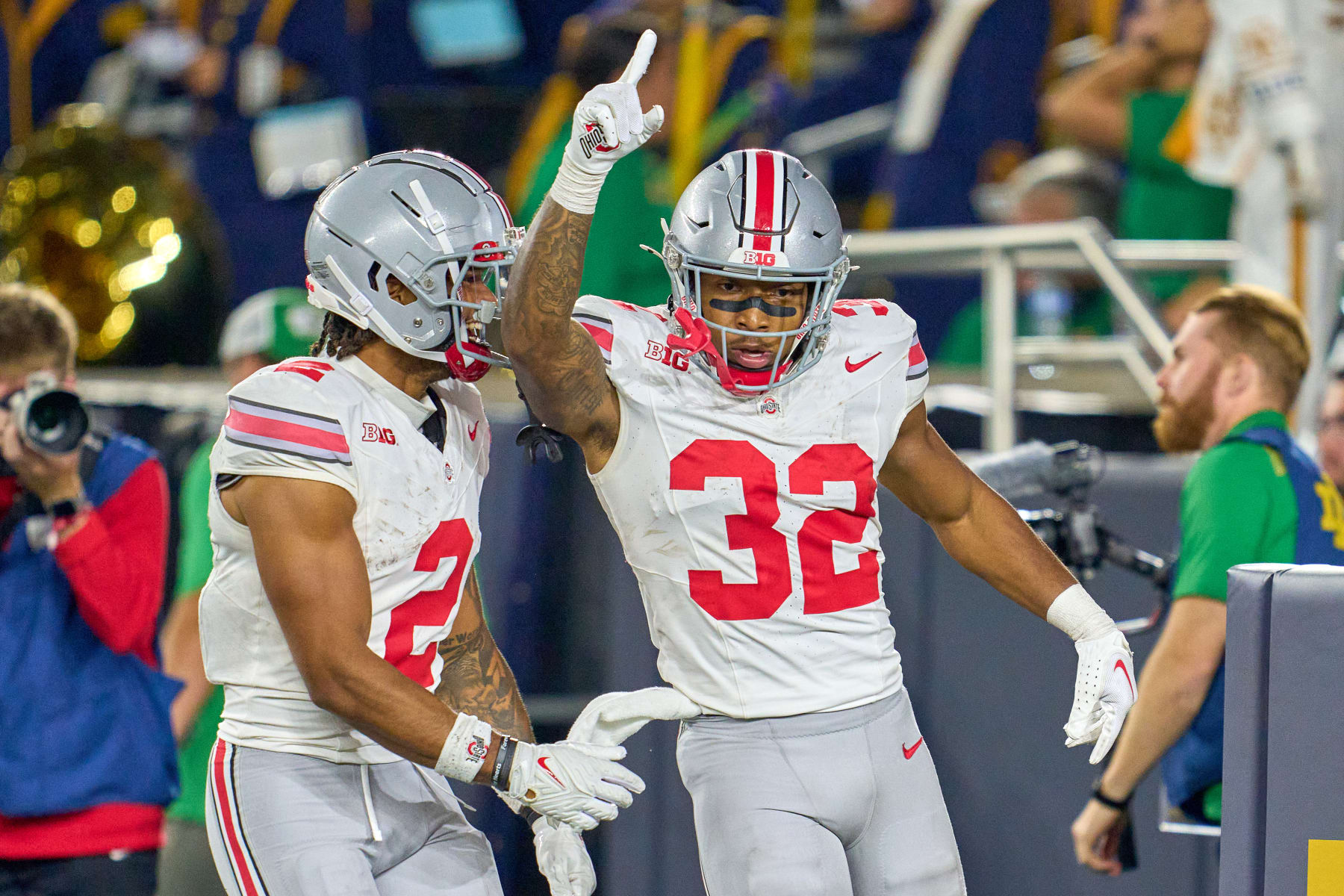 Ohio State Buckeyes running back TreVeyon Henderson (32) celebrates with wide receiver Emeka Egbuka (2).