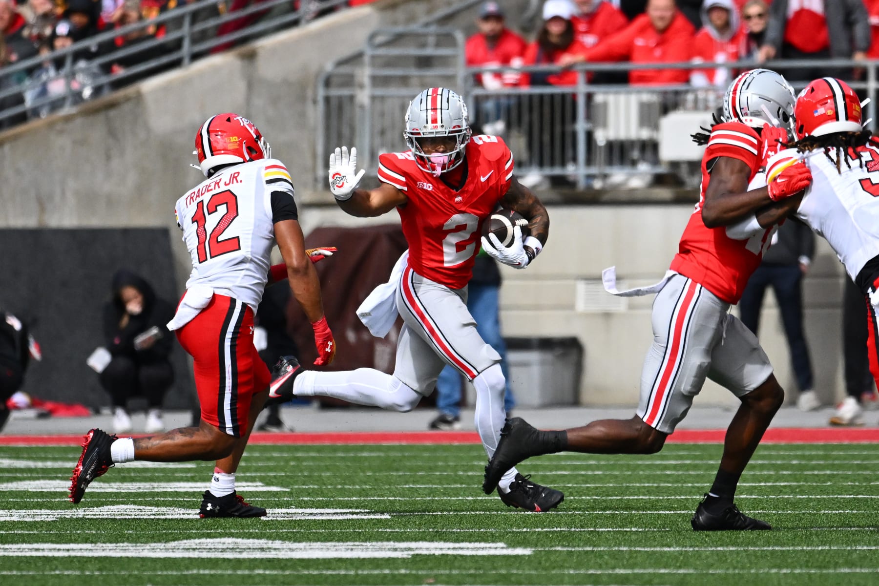 COLUMBUS, OHIO - OCTOBER 07: Emeka Egbuka #2 of the Ohio State Buckeyes runs with the ball as Dante Trader Jr. #12 of the Maryland Terrapins defends during the fourth quarter of a game at Ohio Stadium on October 07, 2023 in Columbus, Ohio. (Photo by Ben Jackson/Getty Images)