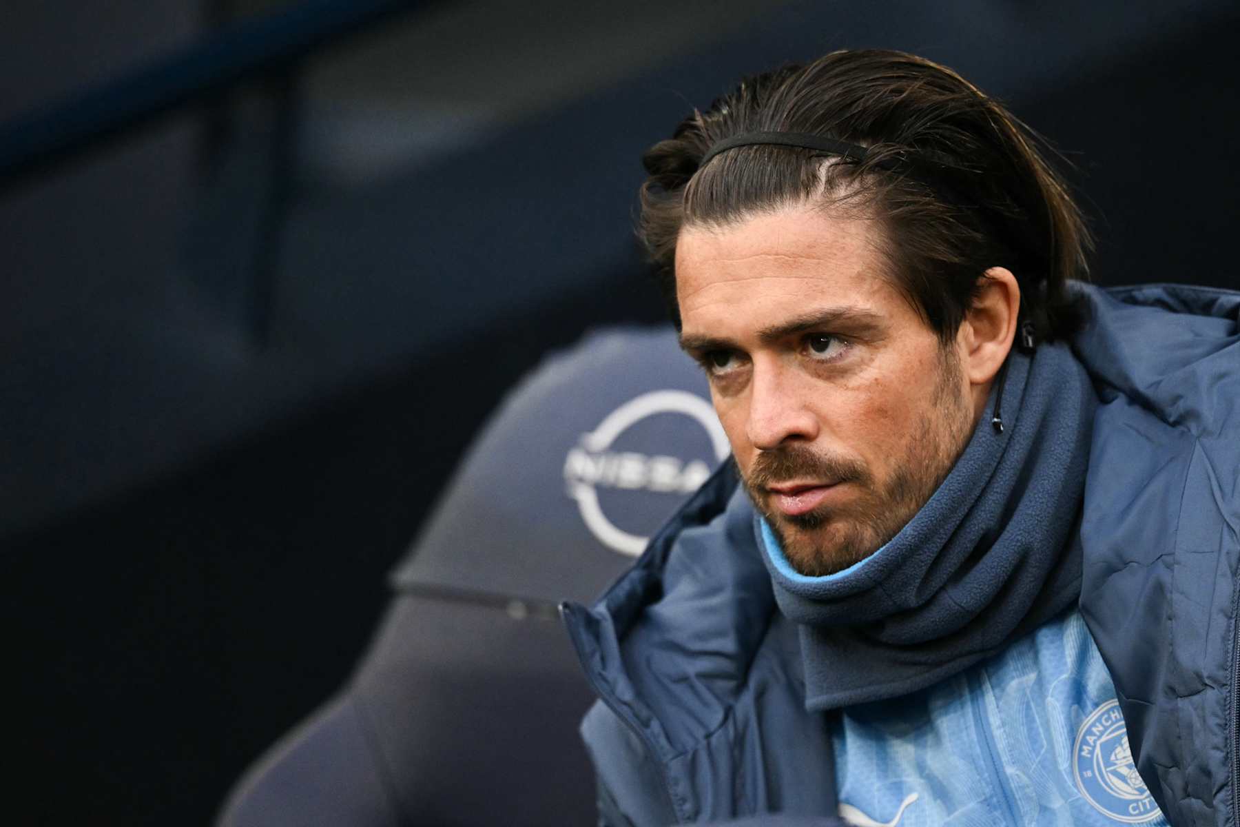 Manchester City's English midfielder #10 Jack Grealish reacts as he sits in on the bench during the English Premier League football match between Manchester City and West Ham United at the Etihad Stadium in Manchester, north west England, on January 4, 2025. (Photo by Oli SCARFF / AFP) / RESTRICTED TO EDITORIAL USE. No use with unauthorized audio, video, data, fixture lists, club/league logos or 'live' services. Online in-match use limited to 120 images. An additional 40 images may be used in extra time. No video emulation. Social media in-match use limited to 120 images. An additional 40 images may be used in extra time. No use in betting publications, games or single club/league/player publications. /  (Photo by OLI SCARFF/AFP via Getty Images)
