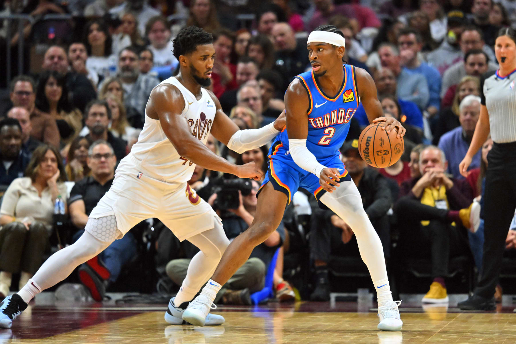 CLEVELAND, OHIO - OCTOBER 27: Shai Gilgeous-Alexander #2 of the Oklahoma City Thunder posts up against Donovan Mitchell #45 of the Cleveland Cavaliers during the third quarter at Rocket Mortgage Fieldhouse on October 27, 2023 in Cleveland, Ohio. The Thunder defeated the Cavaliers 108-105. NOTE TO USER: User expressly acknowledges and agrees that, by downloading and or using this photograph, User is consenting to the terms and conditions of the Getty Images License Agreement. (Photo by Jason Miller/Getty Images)