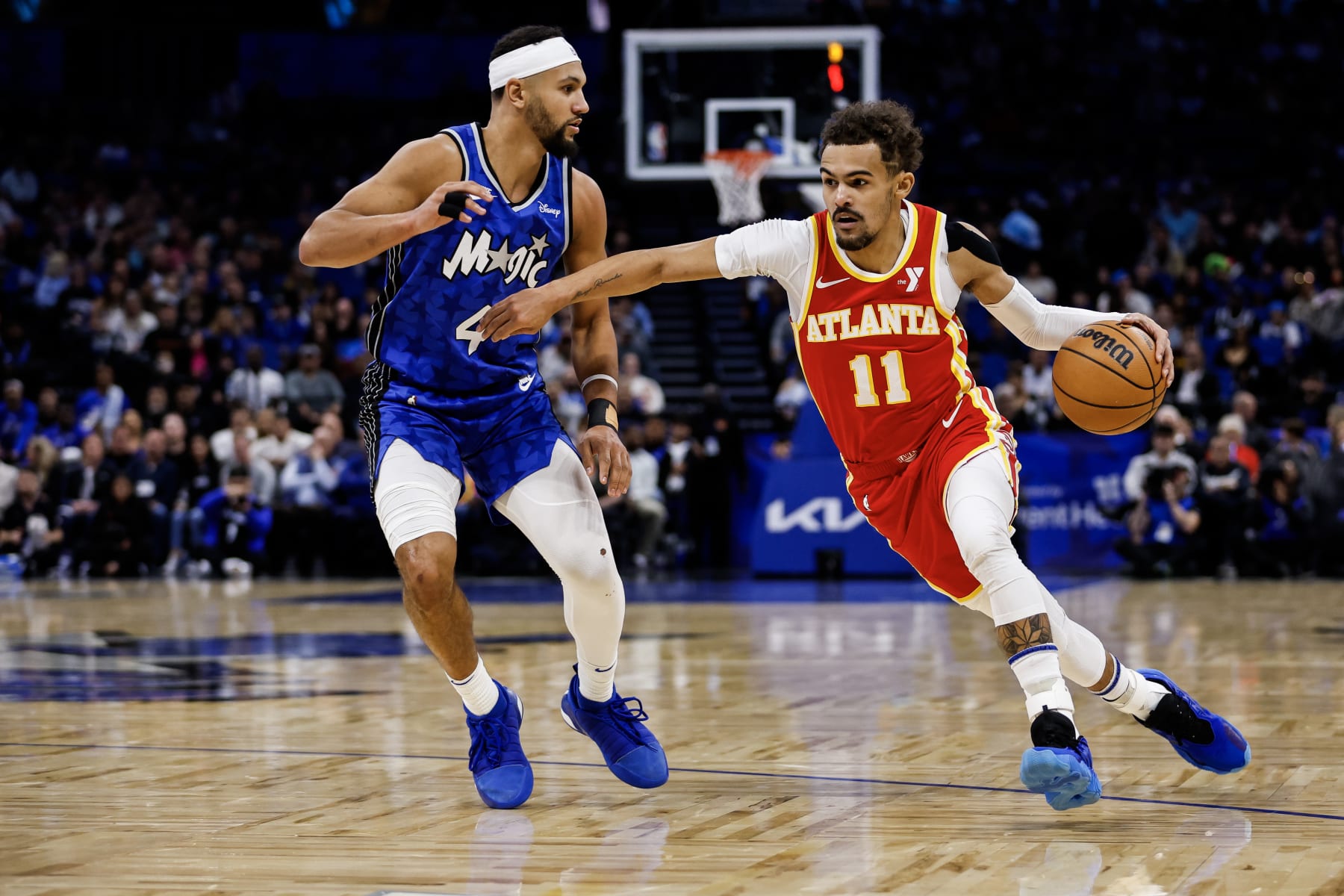 ORLANDO, FLORIDA - JANUARY 07: Trae Young #11 of the Atlanta Hawks dribbles the ball against Jalen Suggs #4 of the Orlando Magic during the first half of a game at the Kia Center on January 07, 2024 in Orlando, Florida. NOTE TO USER: User expressly acknowledges and agrees that, by downloading and or using this photograph, User is consenting to the terms and conditions of the Getty Images License Agreement. (Photo by James Gilbert/Getty Images)