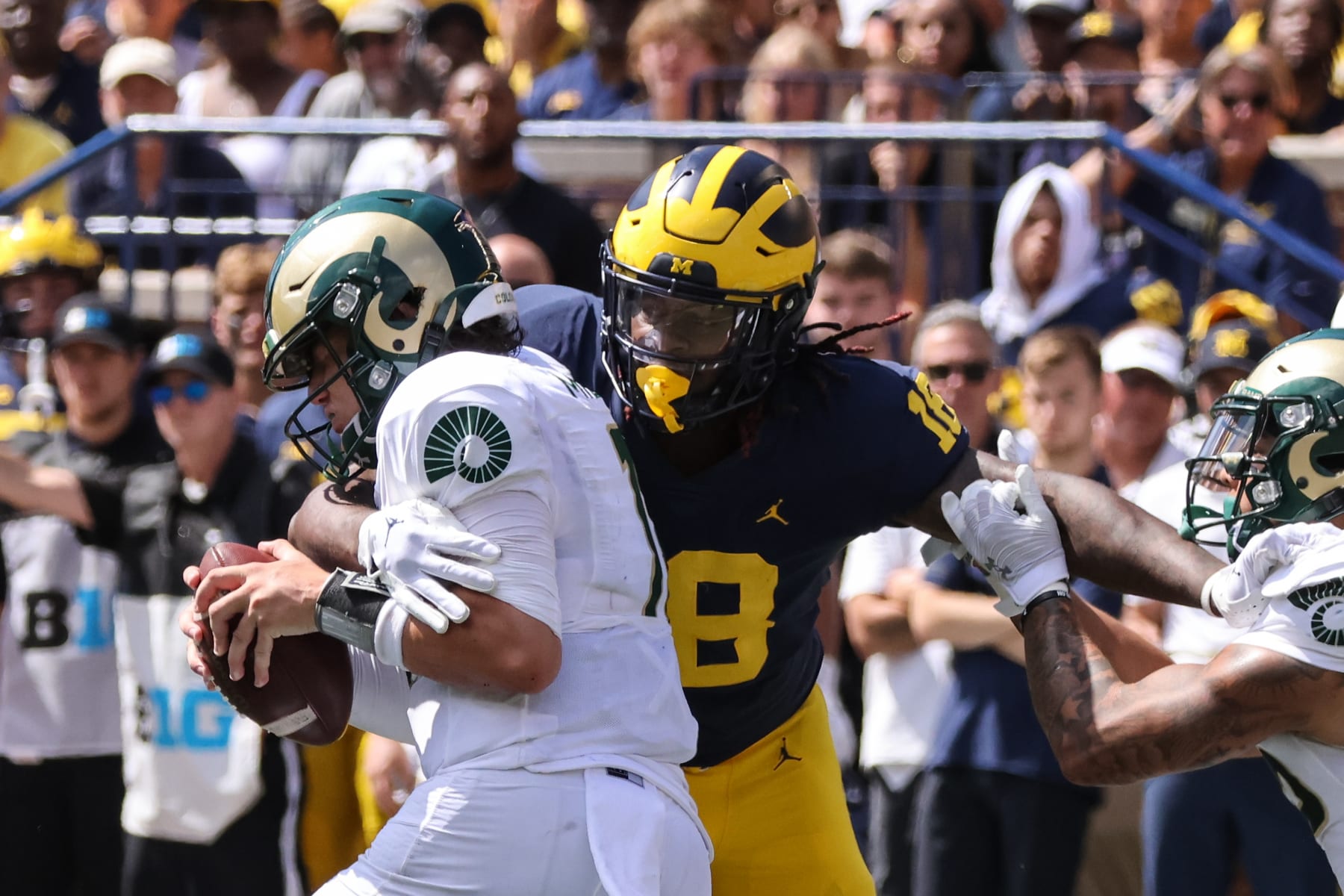 ANN ARBOR, MI - SEPTEMBER 03:  Michigan Wolverines defensive end Eyabi Anoma (18) wraps his arms around Colorado State Rams quarterback Clay Millen (11) during the second quarter of a non-conference college football game between the Colorado State Rams and the Michigan Wolverines on September 3, 2022 at Michigan Stadium in Ann Arbor, Michigan.  (Photo by Scott W. Grau/Icon Sportswire via Getty Images)
