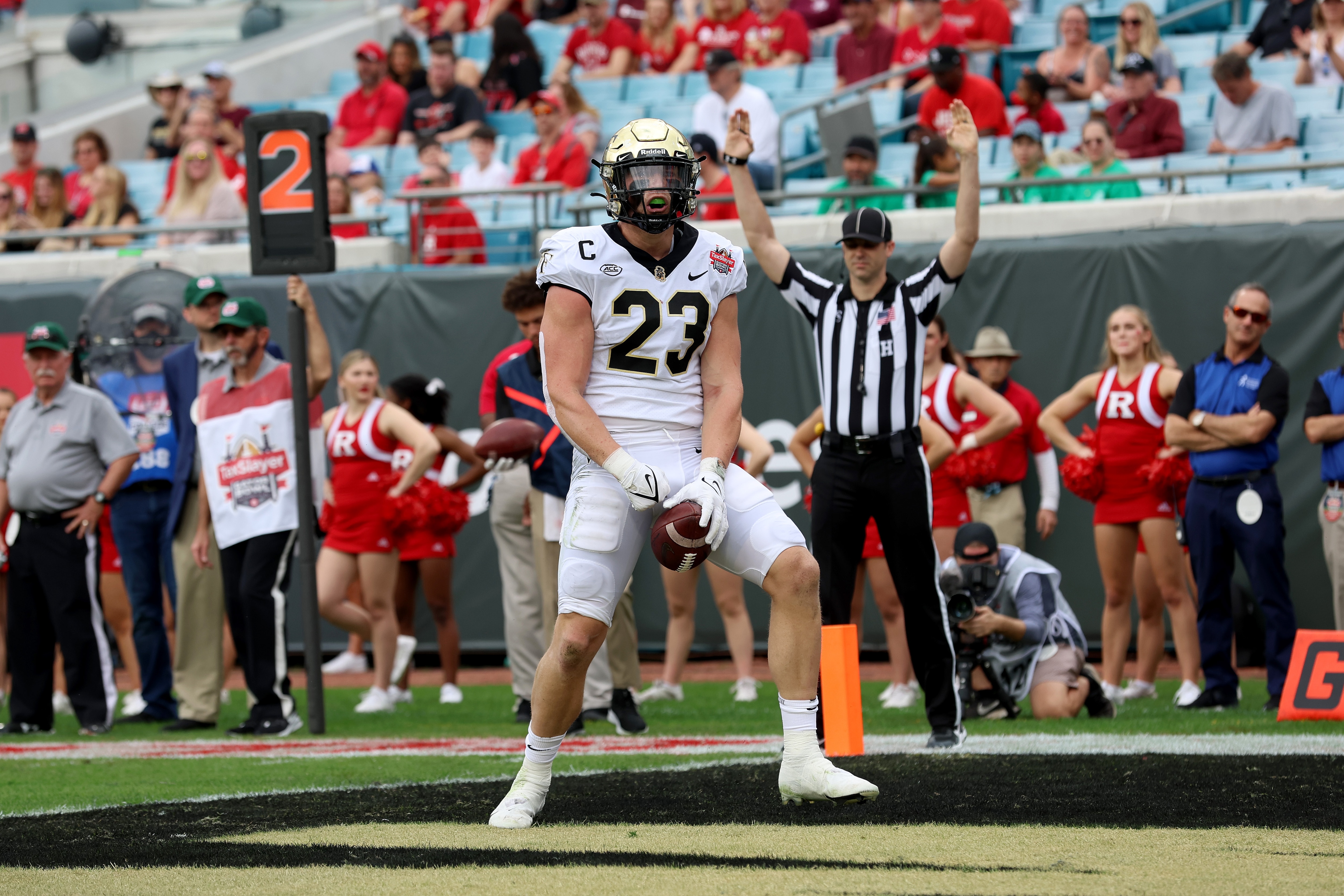 JACKSONVILLE, FLORIDA - DECEMBER 31: Brandon Chapman #23 of the Wake Forest Demon Deacons celebrates a touch against the Rutgers Scarlet Knights during the TaxSlayer Gator Bowl at TIAA Bank Field on December 31, 2021 in Jacksonville, Florida. (Photo by Sam Greenwood/Getty Images)