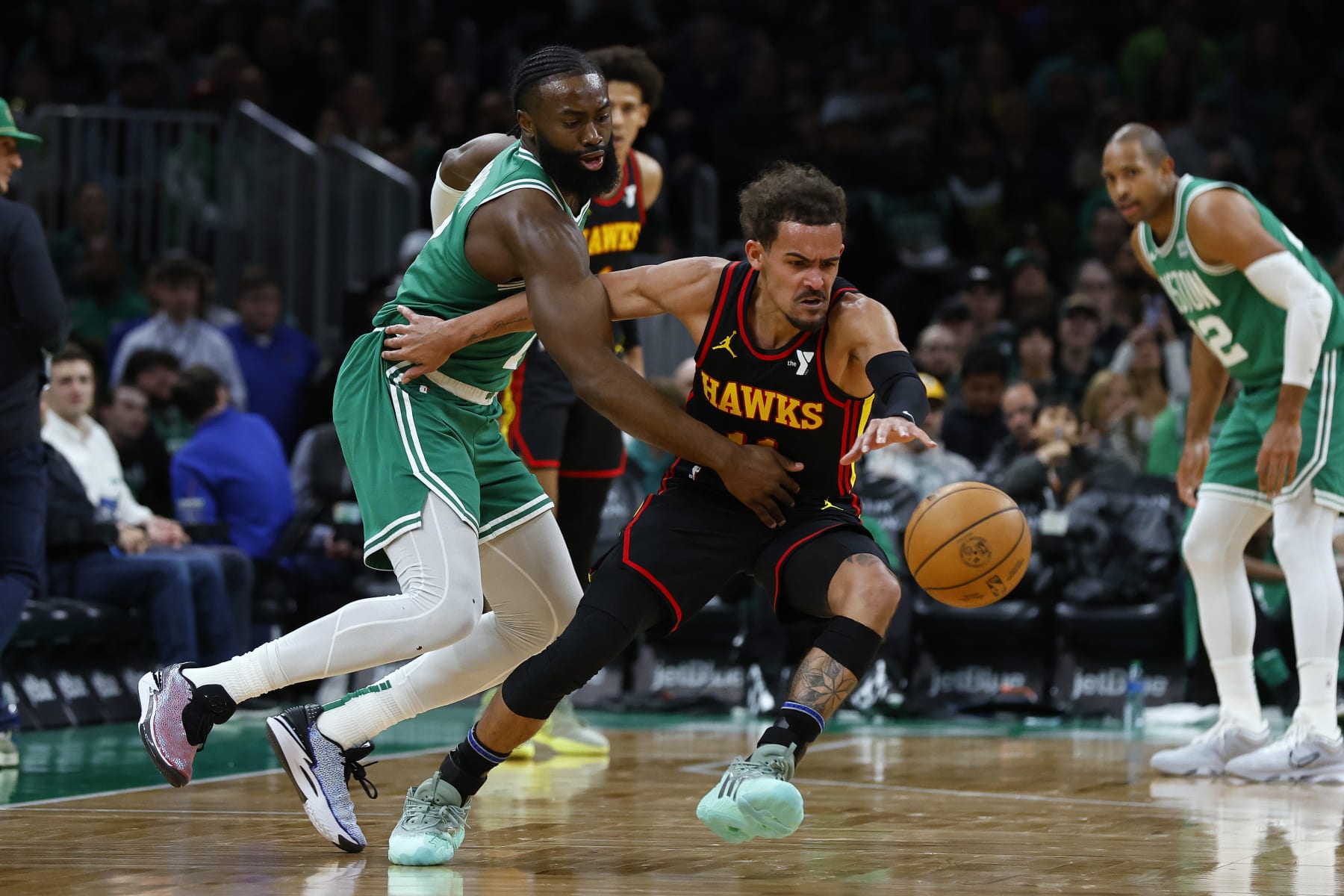 BOSTON, MA - FEBRUARY 7: Trae Young #11 of the Atlanta Hawks reaches for a loose ball against Jaylen Brown #7 of the Boston Celtics during the second half at TD Garden on February 7, 2024 in Boston, Massachusetts. NOTE TO USER: User expressly acknowledges and agrees that, by downloading and/or using this Photograph, user is consenting to the terms and conditions of the Getty Images License Agreement. (Photo By Winslow Townson/Getty Images)