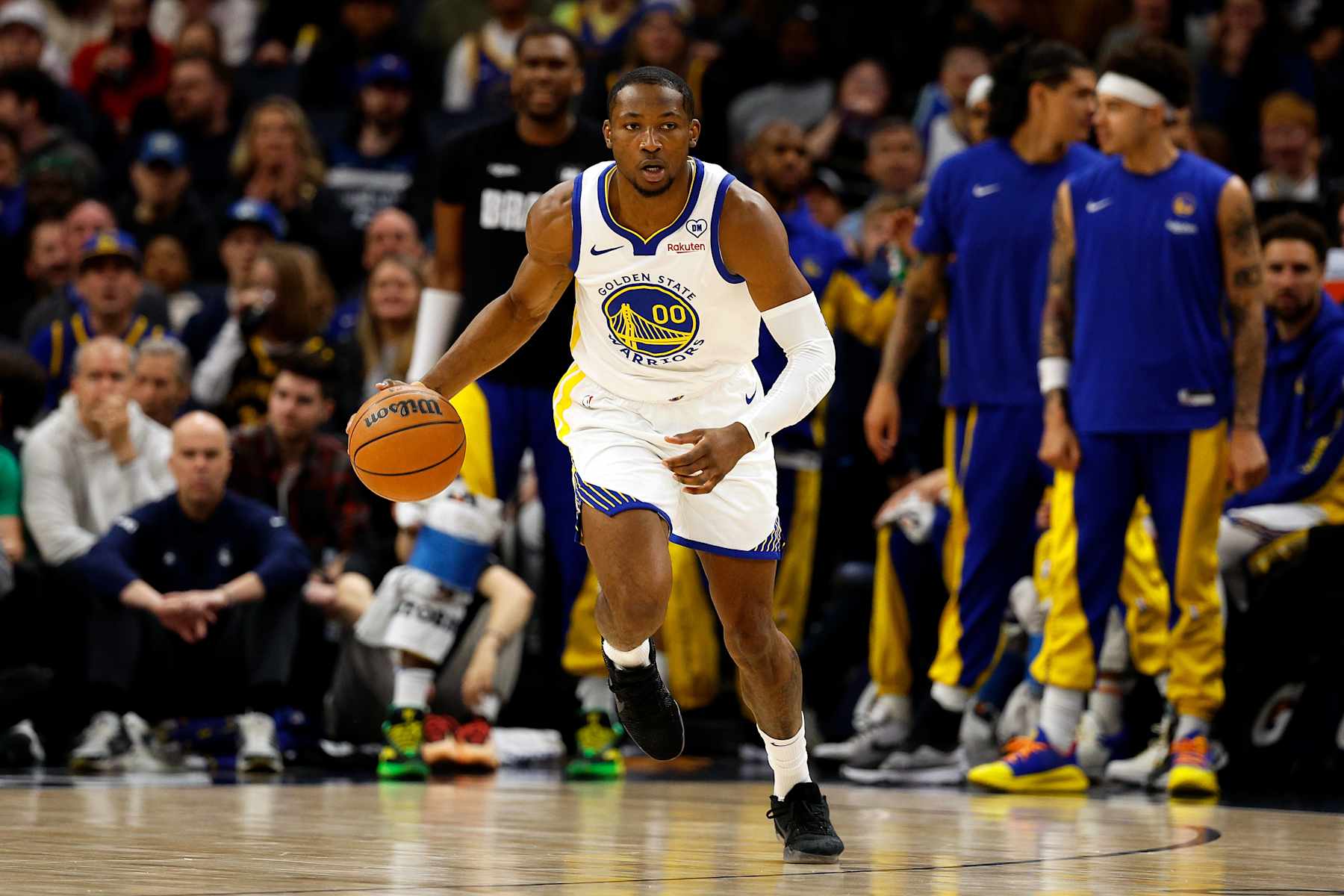 MINNEAPOLIS, MINNESOTA - MARCH 24: Jonathan Kuminga #00 of the Golden State Warriors dribbles the ball against the Minnesota Timberwolves in the first quarter at Target Center on March 24, 2024 in Minneapolis, Minnesota. The Timberwolves defeated the Warriors 114-110. NOTE TO USER: User expressly acknowledges and agrees that, by downloading and or using this photograph, User is consenting to the terms and conditions of the Getty Images License Agreement. (Photo by David Berding/Getty Images)