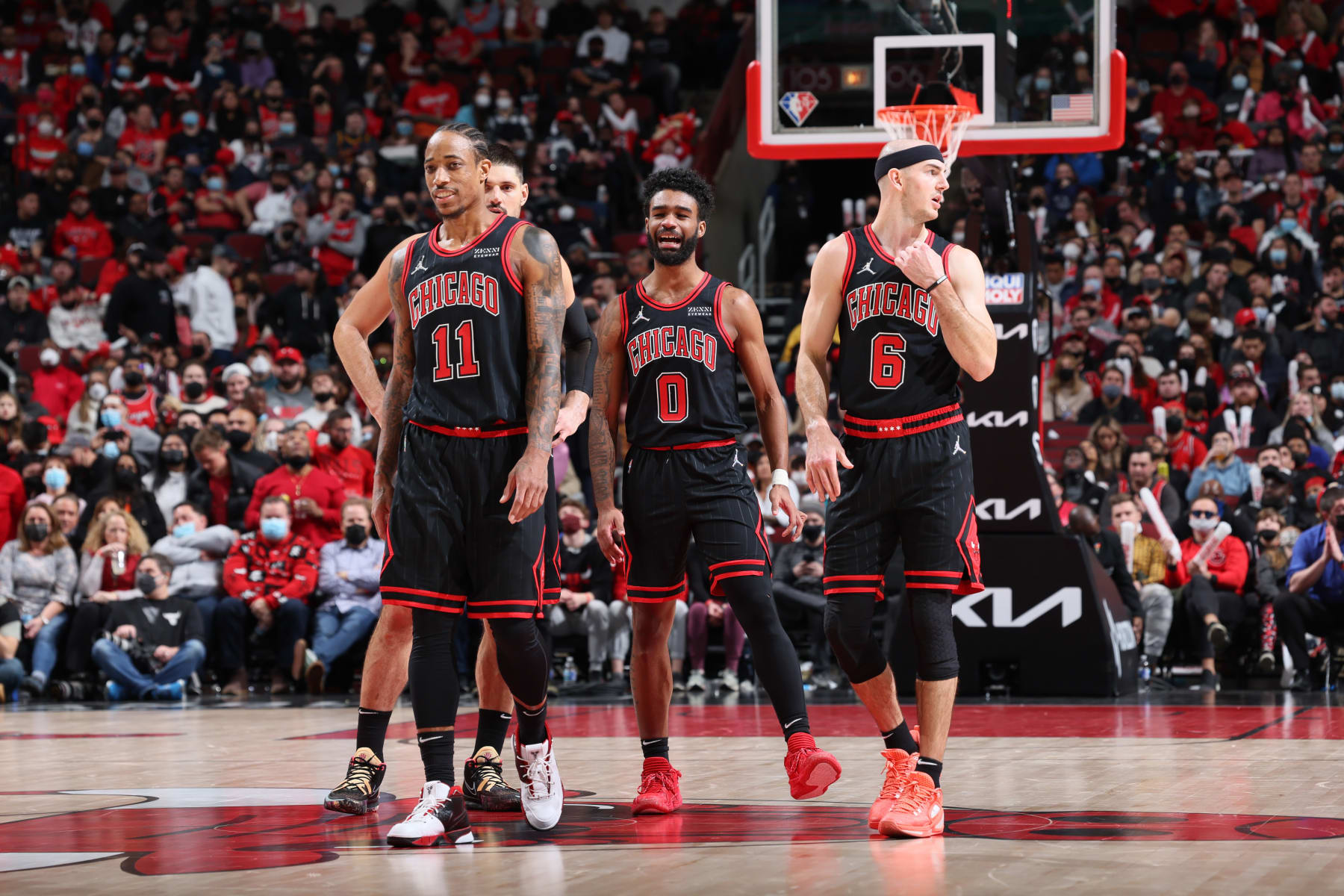 CHICAGO, IL - JANUARY 19: DeMar DeRozan #11, Nikola Vucevic #9, Coby White #0 and Alex Caruso #6 of the Chicago Bulls look on during the game against the Cleveland Cavaliers on January 19, 2022 at United Center in Chicago, Illinois. NOTE TO USER: User expressly acknowledges and agrees that, by downloading and or using this photograph, User is consenting to the terms and conditions of the Getty Images License Agreement. Mandatory Copyright Notice: Copyright 2022 NBAE (Photo by Jeff Haynes/NBAE via Getty Images)