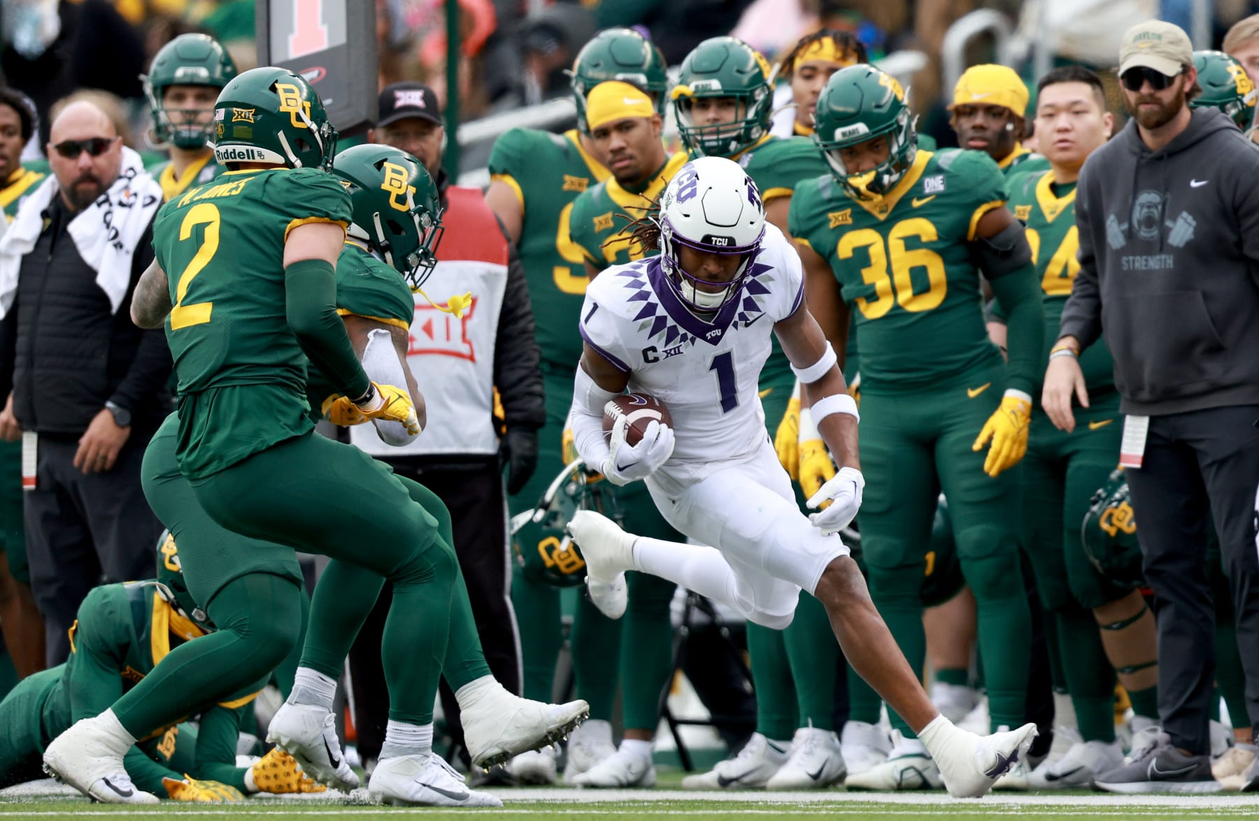 WACO, TEXAS - NOVEMBER 19: Wide receiver Quentin Johnston #1 of the TCU Horned Frogs carries the ball against cornerback AJ McCarty #19 of the Baylor Bears and linebacker Matt Jones #2 of the Baylor Bears in the first half at McLane Stadium on November 19, 2022 in Waco, Texas. (Photo by Tom Pennington/Getty Images)