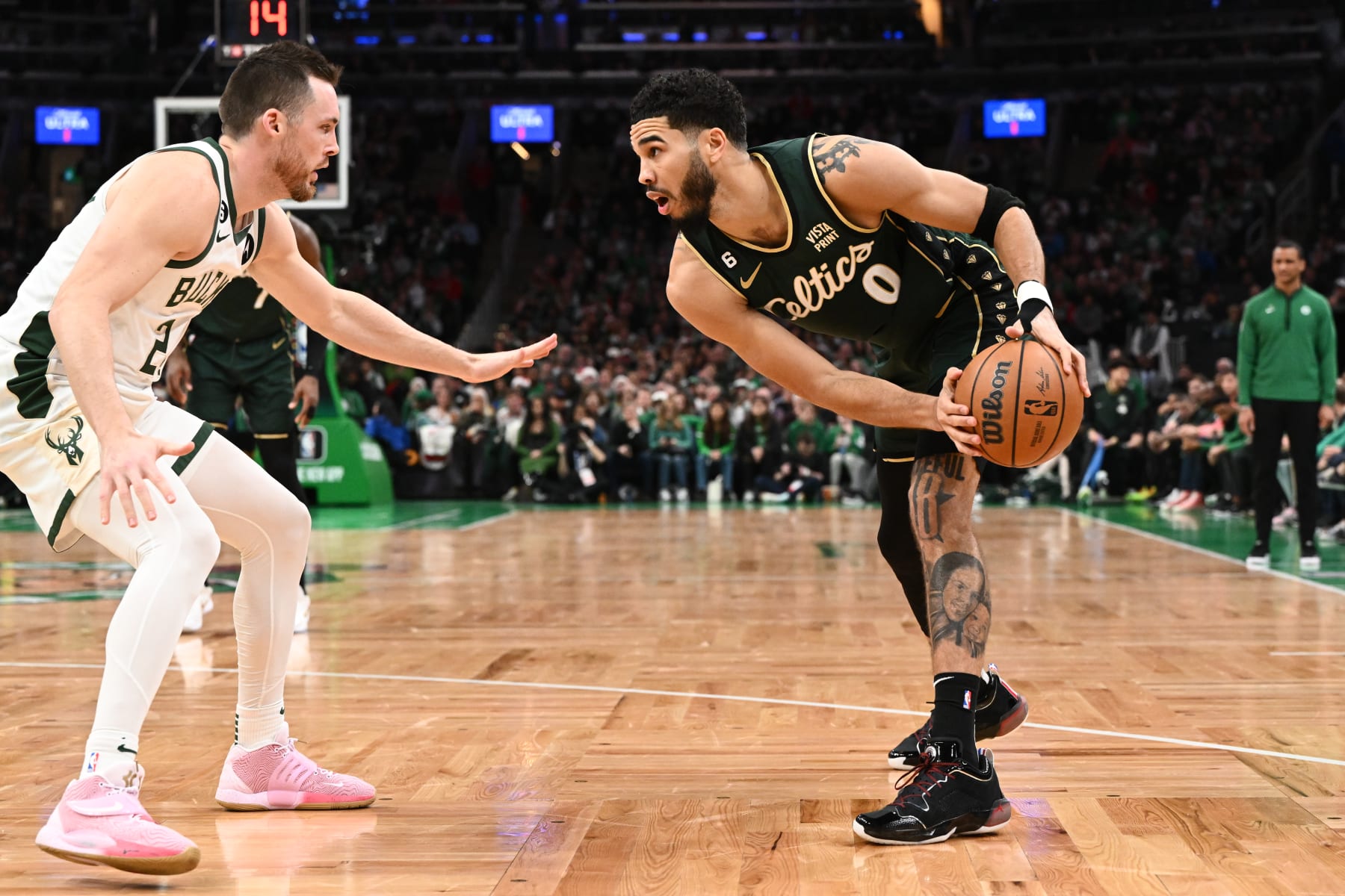 BOSTON, MASSACHUSETTS - DECEMBER 25: Pat Connaughton #24 of the Milwaukee Bucks defends Jayson Tatum #0 of the Boston Celtics during the second quarter at the TD Garden on December 25, 2022 in Boston, Massachusetts. NOTE TO USER: User expressly acknowledges and agrees that, by downloading and or using this photograph, User is consenting to the terms and conditions of the Getty Images License Agreement. (Photo by Brian Fluharty/Getty Images)