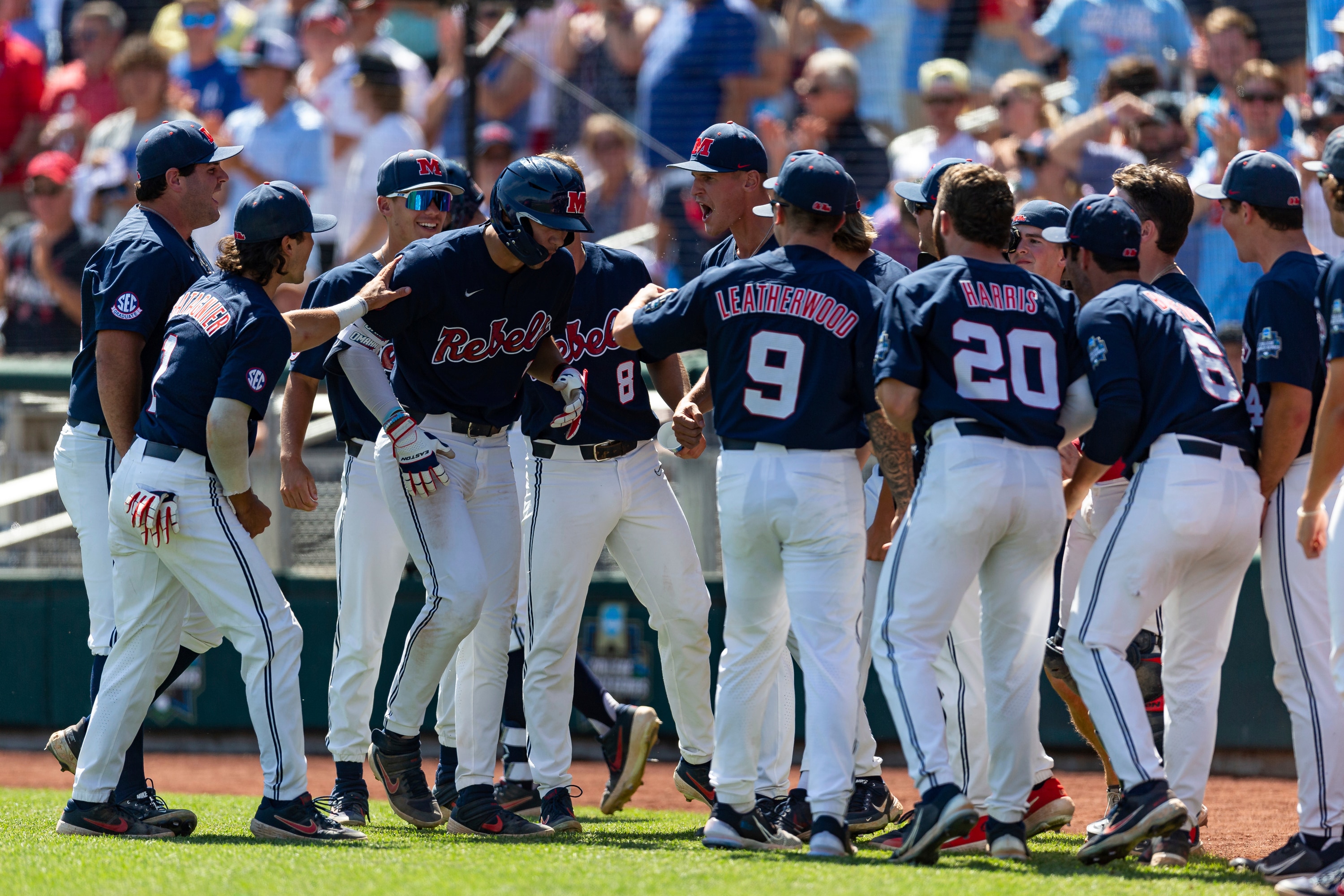 Mississippi's Jacob Gonzalez (7) celebrates his home run against Oklahoma with teammates in the sixth inning in Game 2 of the NCAA College World Series baseball finals, Sunday, June 26, 2022, in Omaha, Neb. (AP Photo/John Peterson)