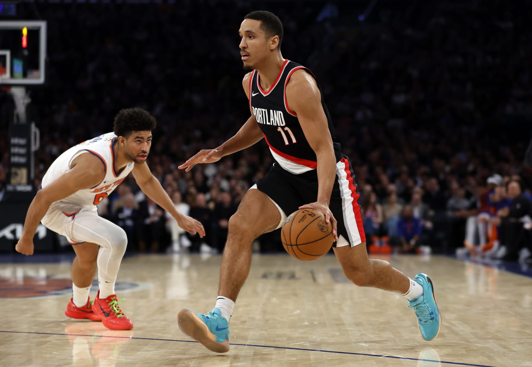 NEW YORK, NEW YORK - JANUARY 09: Malcolm Brogdon #11 of the Portland Trail Blazers dribbles against Quentin Grimes #6 of the New York Knicks during the first half at Madison Square Garden on January 09, 2024 in New York City. NOTE TO USER: User expressly acknowledges and agrees that, by downloading and/or using this Photograph, user is consenting to the terms and conditions of the Getty Images License Agreement. (Photo by Sarah Stier/Getty Images)