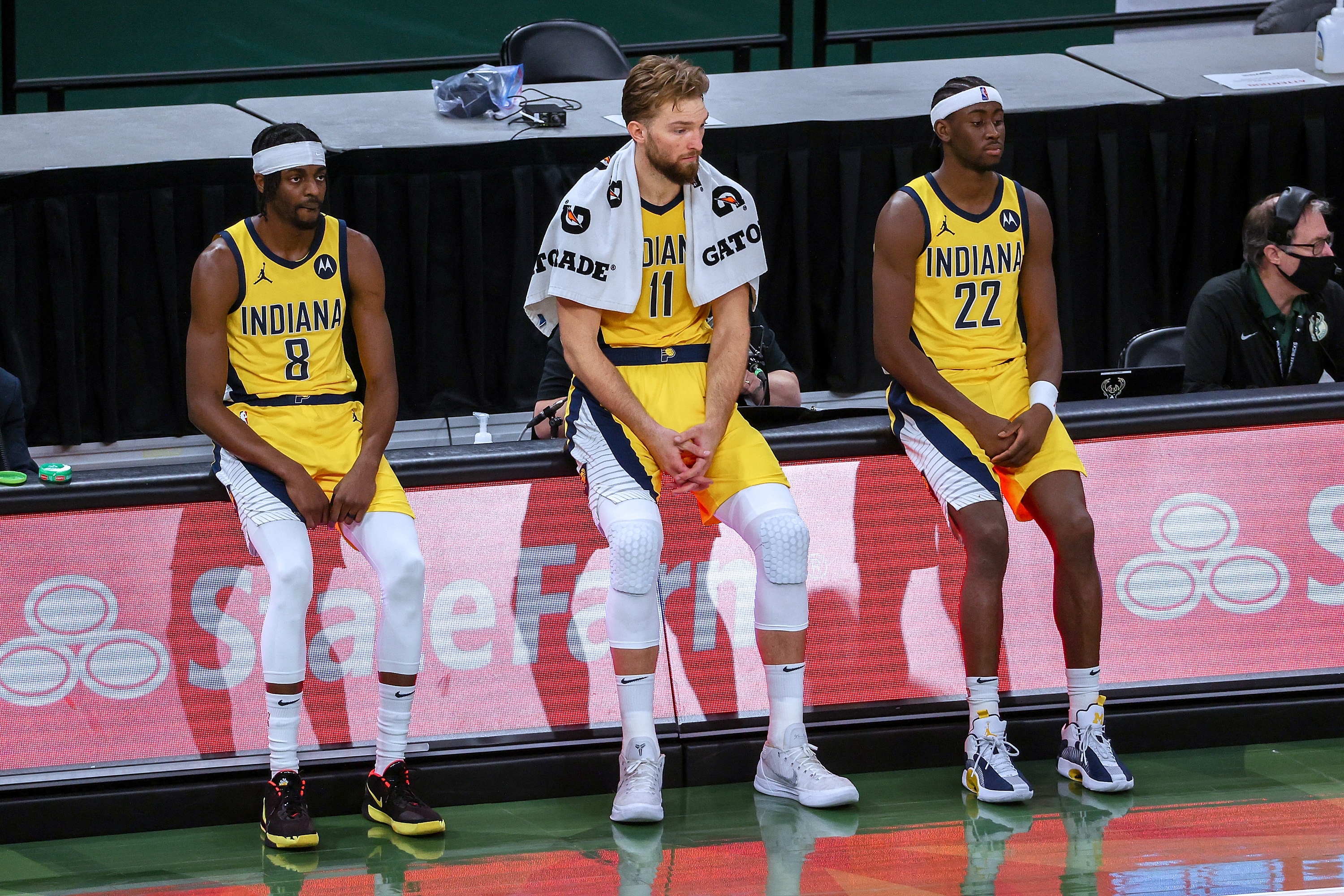 MILWAUKEE, WISCONSIN - MARCH 22: Justin Holiday #8, Domantas Sabonis #11, and Caris LeVert #22 of the Indiana Pacers look on during a timeout in the third quarter against the Milwaukee Bucks at the Fiserv Forum on March 22, 2021 in Milwaukee, Wisconsin. NOTE TO USER: User expressly acknowledges and agrees that, by downloading and or using this photograph, User is consenting to the terms and conditions of the Getty Images License Agreement. (Photo by Dylan Buell/Getty Images)