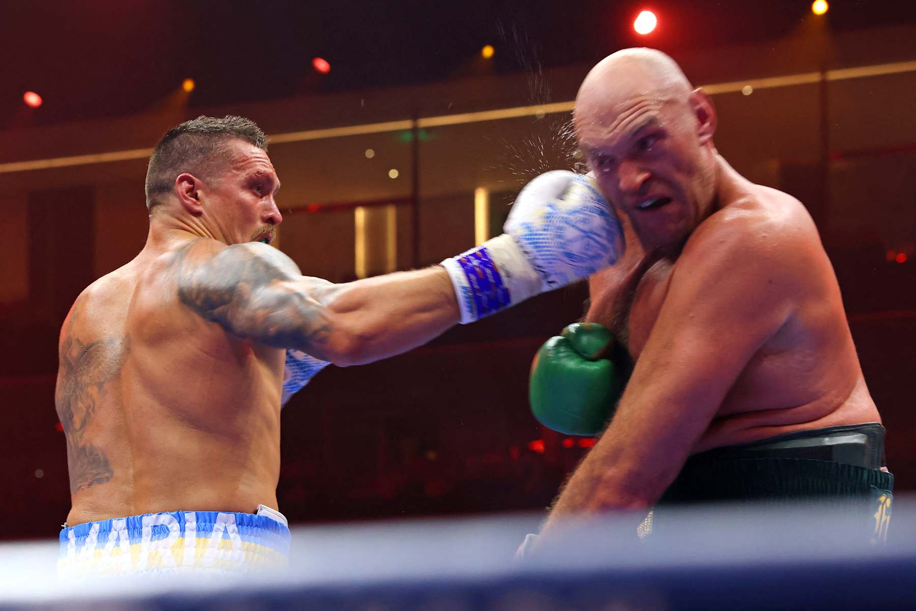 Ukraine's Oleksandr Usyk (L) fights against Britain's Tyson Fury during a heavyweight boxing world championship fight at Kingdom Arena in Riyadh, Saudi Arabia on May 19, 2024. Oleksandr Usyk beat Tyson Fury by split decision to win the world's first undisputed heavyweight championship in 25 years on May 19, 2024, an unprecedented feat in boxing's four-belt era. (Photo by Fayez NURELDINE / AFP) (Photo by FAYEZ NURELDINE/AFP via Getty Images)