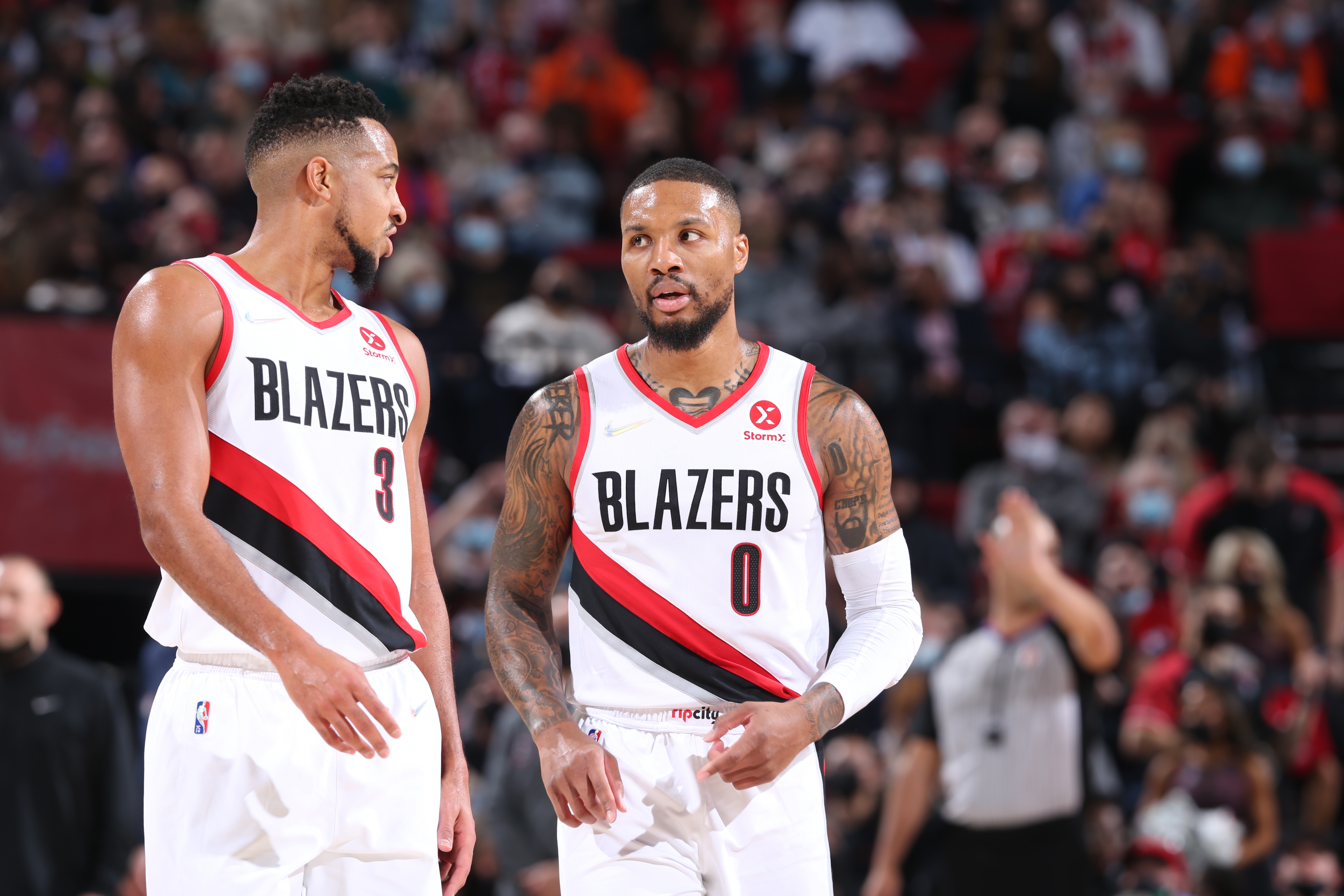 PORTLAND, OR - NOVEMBER 23: CJ McCollum #3 and Damian Lillard #0 of the Portland Trail Blazers talk during the game against the Denver Nuggets on November 23, 2021 at the Moda Center Arena in Portland, Oregon. NOTE TO USER: User expressly acknowledges and agrees that, by downloading and or using this photograph, user is consenting to the terms and conditions of the Getty Images License Agreement. Mandatory Copyright Notice: Copyright 2021 NBAE (Photo by Sam Forencich/NBAE via Getty Images)
