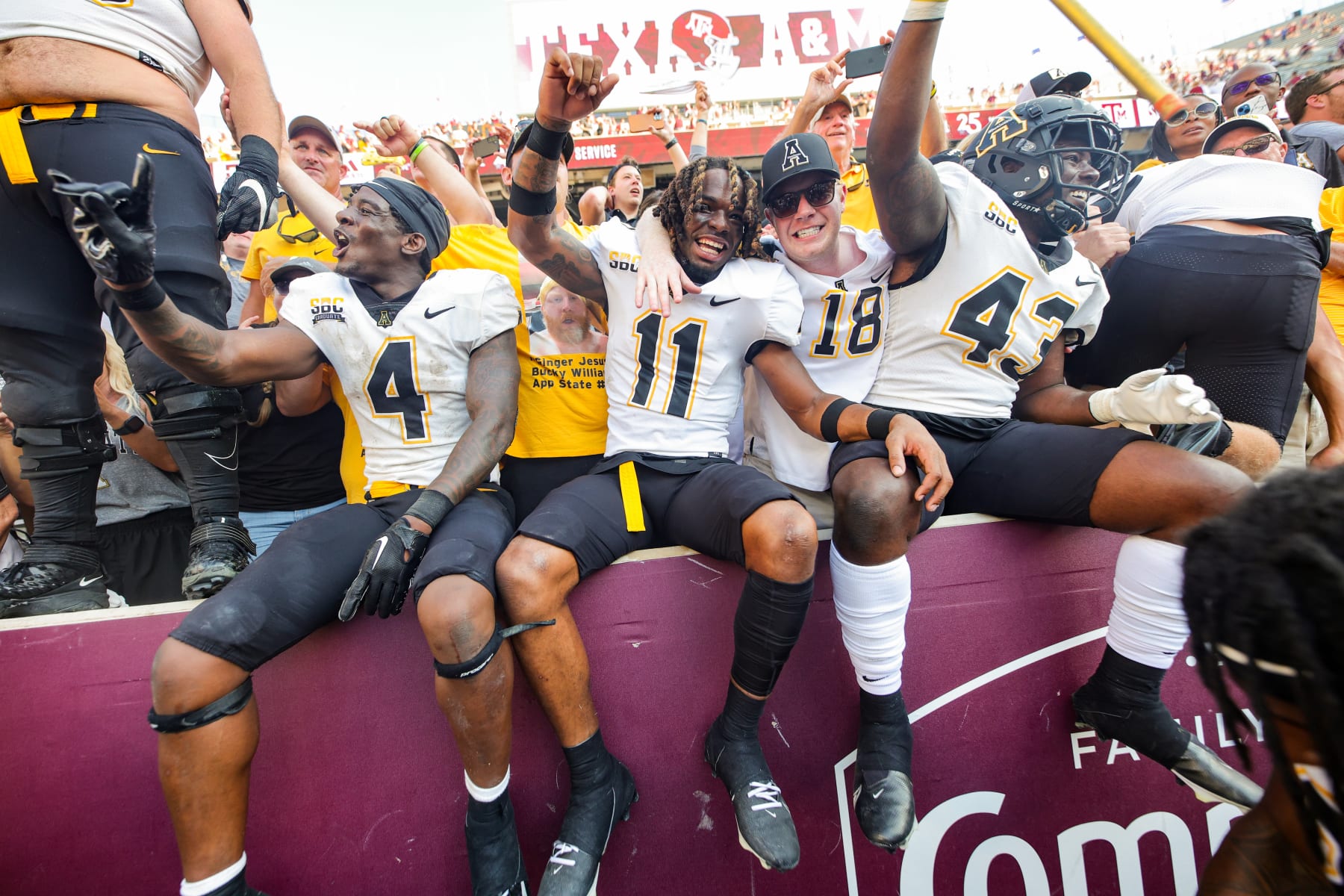 COLLEGE STATION, TEXAS - SEPTEMBER 10: Jordan Favors #11, Hansky Paillant #43, and Daetrich Harrington #4 of the Appalachian State Mountaineers celebrate defeating the Texas A&M Aggies at Kyle Field on September 10, 2022 in College Station, Texas. (Photo by Carmen Mandato/Getty Images)