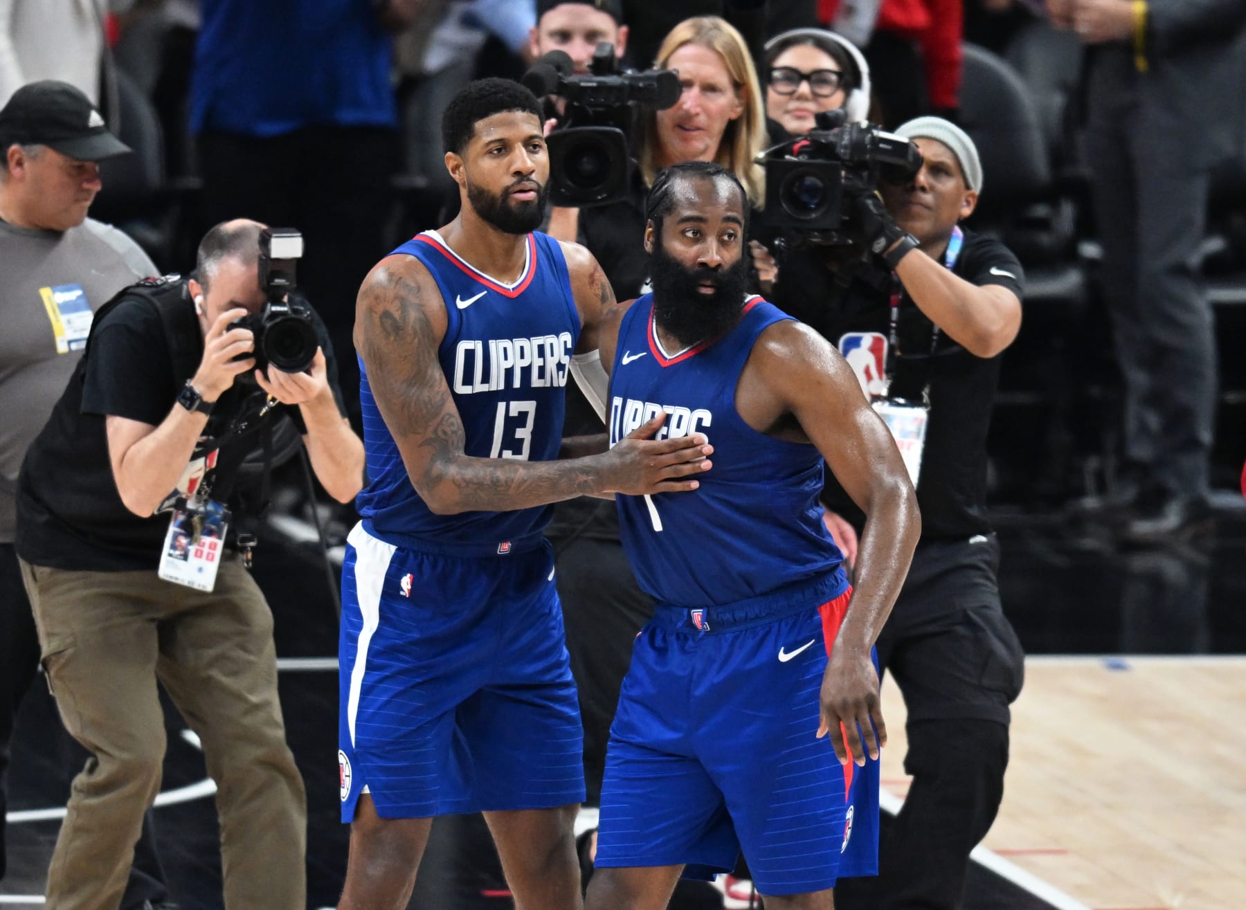 LOS ANGELES, CA - JANUARY 16: Paul George (13) of the LA Clippers and James Harden (1) of the LA Clippers celebrate a win over the Oklahoma City Thunder after a NBA basketball game on January 16, 2024 at Crypto.com Arena in Los Angeles, CA. (Photo by John McCoy/Icon Sportswire via Getty Images)