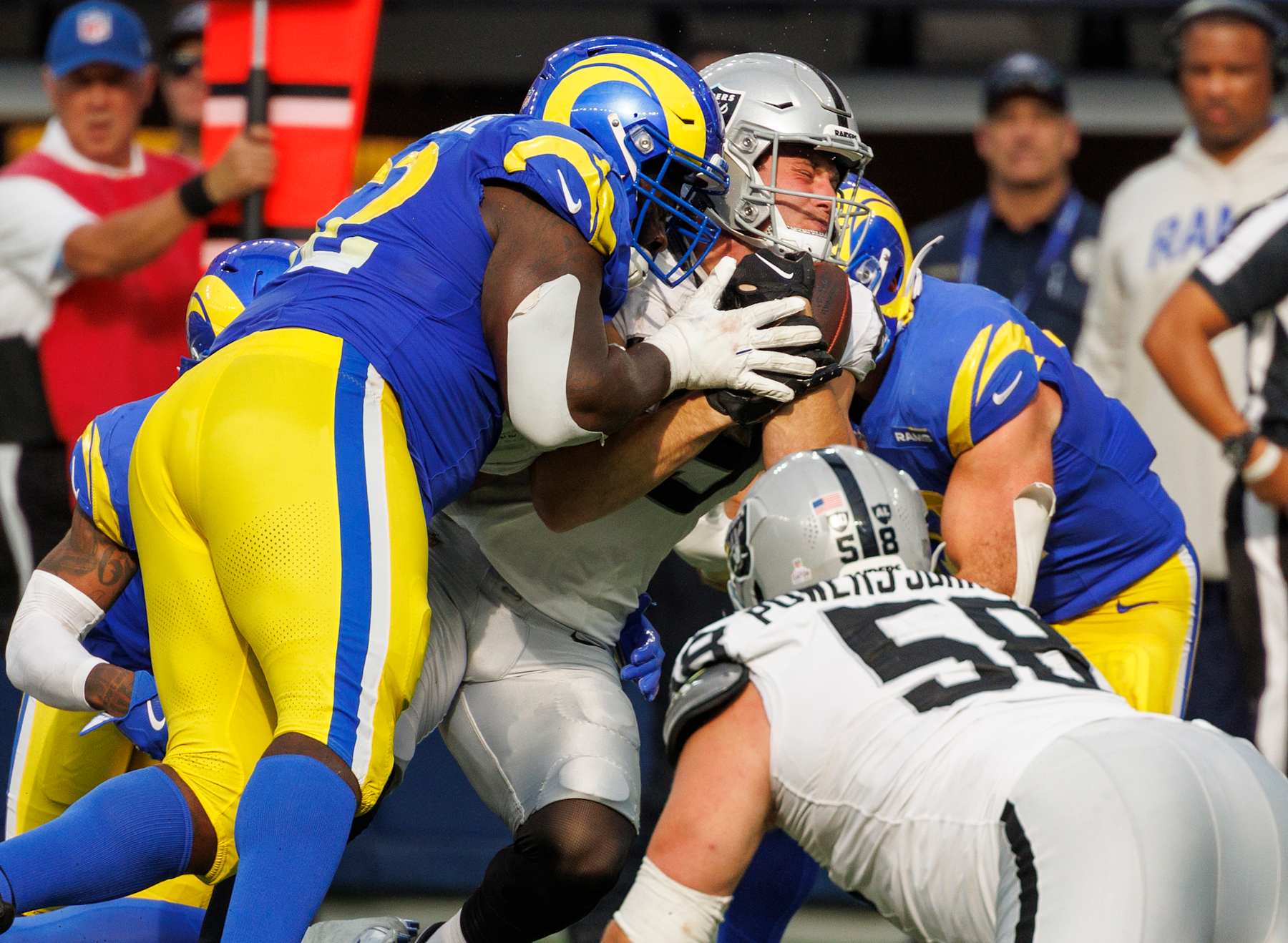 INGLEWOOD, CA - OCTOBER 20, 2024: Los Angeles Rams defensive tackle Neville Gallimore (92) tackles Las Vegas Raiders tight end Brock Bowers (89) in the second half  at So-Fi Stadium on October 20,  2024 in Inglewood, California. (Gina Ferazzi / Los Angeles Times via Getty Images)