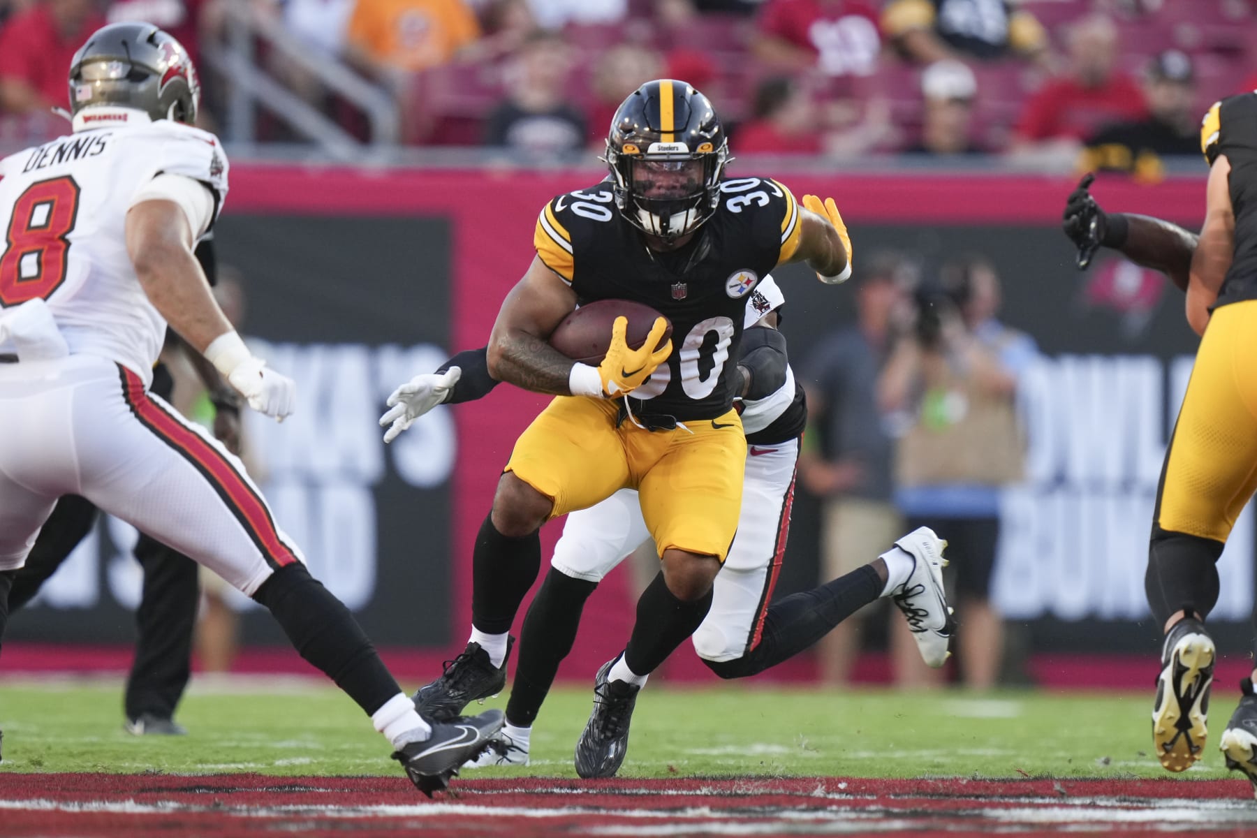 Pittsburgh Steelers running back Jaylen Warren (30) rushes with the ball in the first quarter during an NFL preseason football game against the Tampa Bay Buccaneers, Friday, Aug. 11, 2023, in Tampa, Fla. (AP Photo/Peter Joneleit)